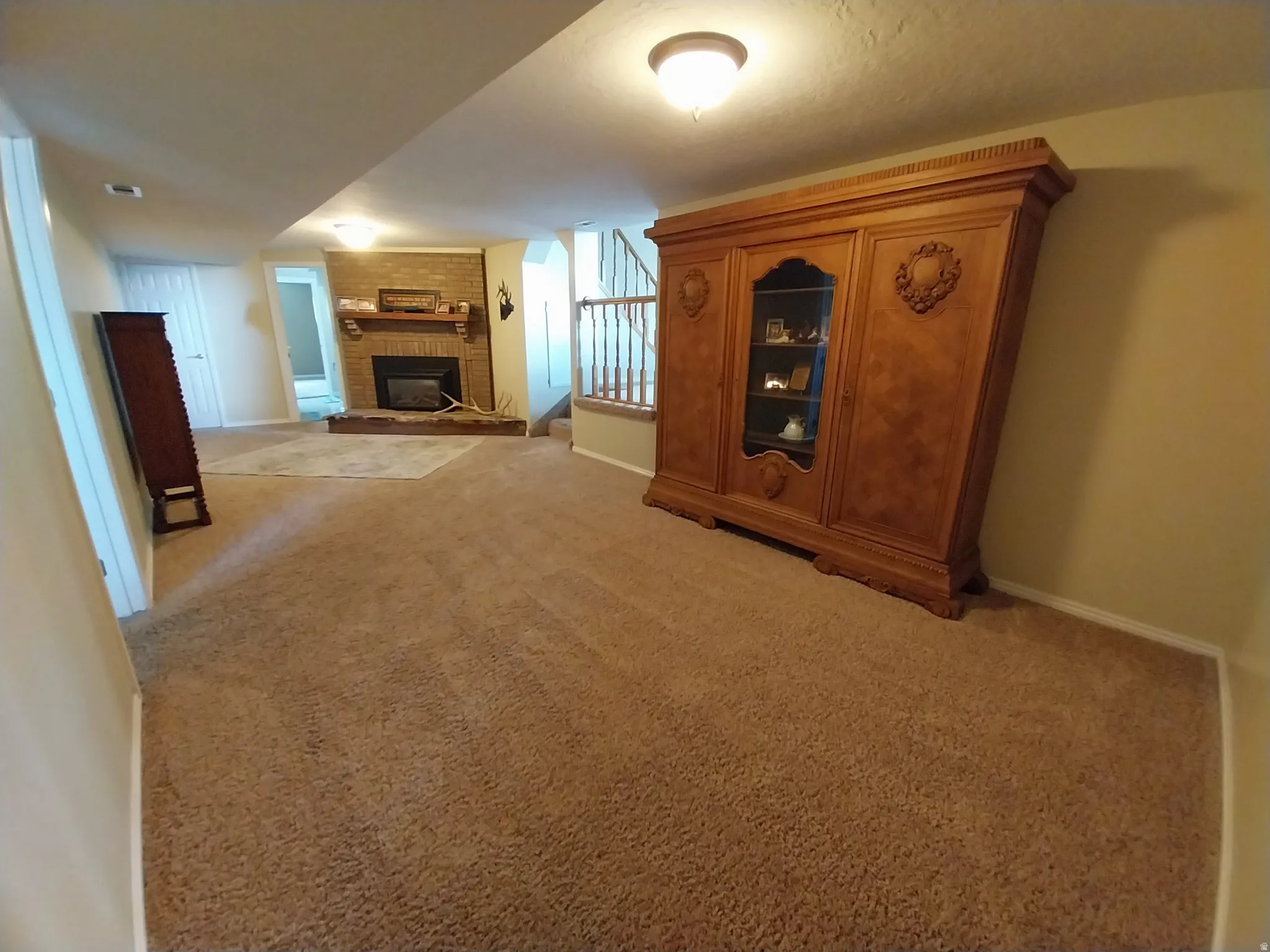 Potential cinema area, featuring light carpet and a fireplace