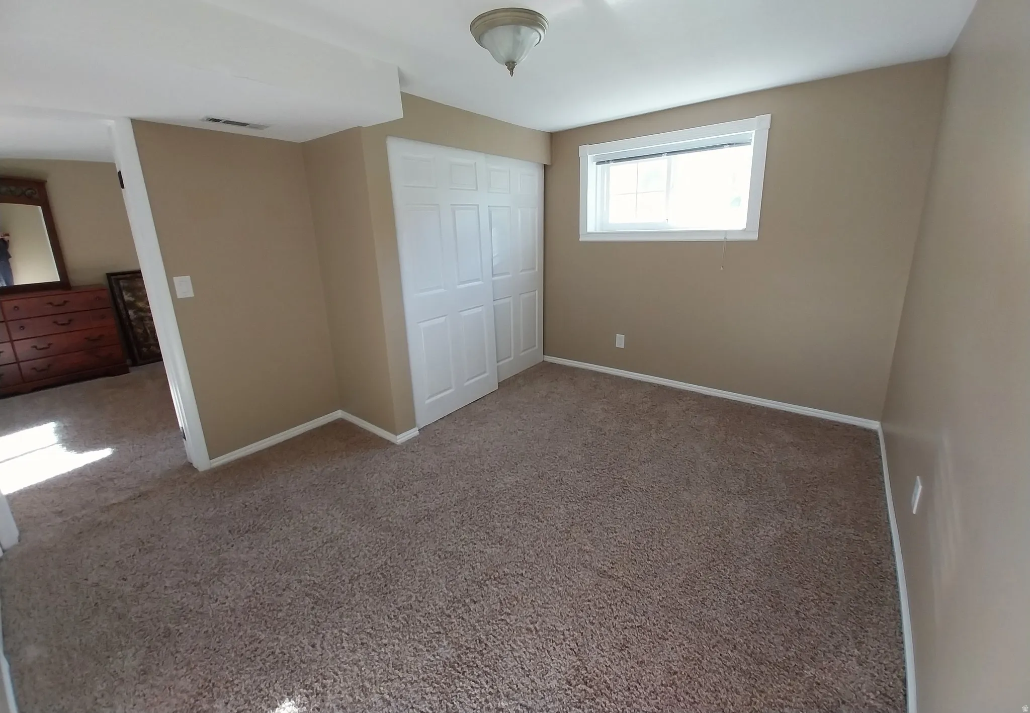 Unfurnished bedroom with carpet flooring and a closet