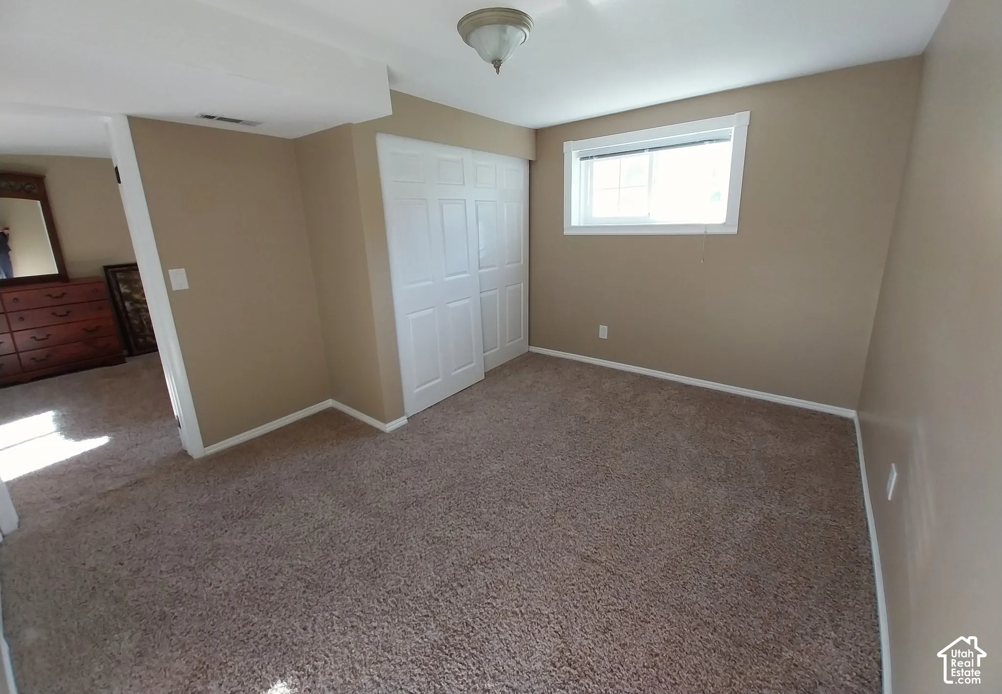 Unfurnished bedroom with carpet flooring and a closet