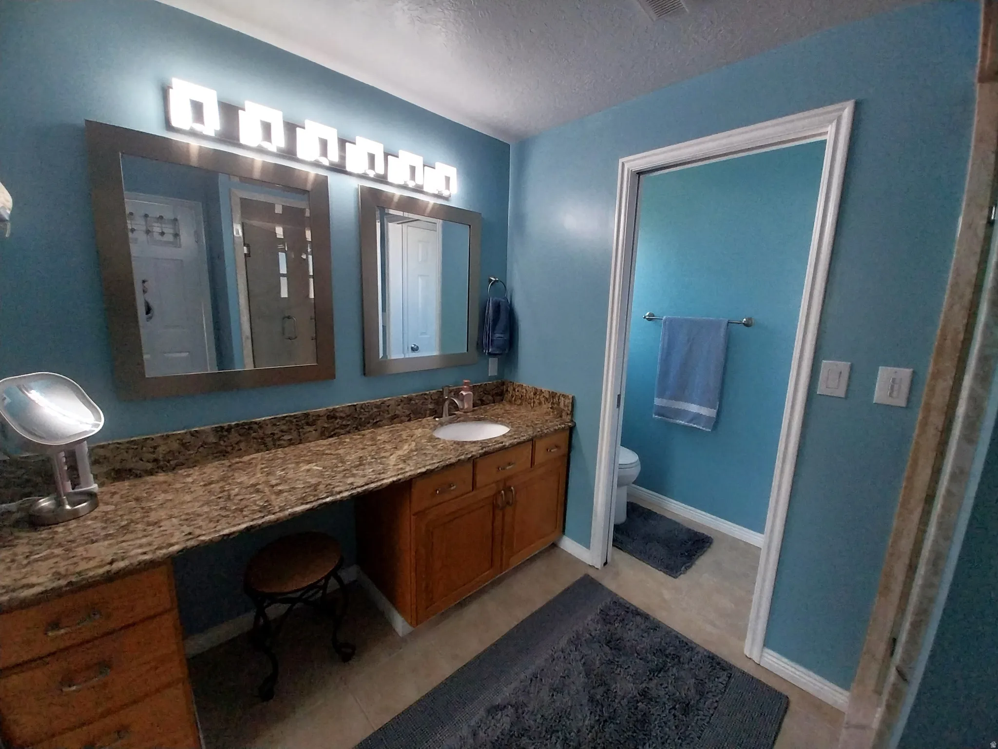 Full bathroom with vanity and a shower stall