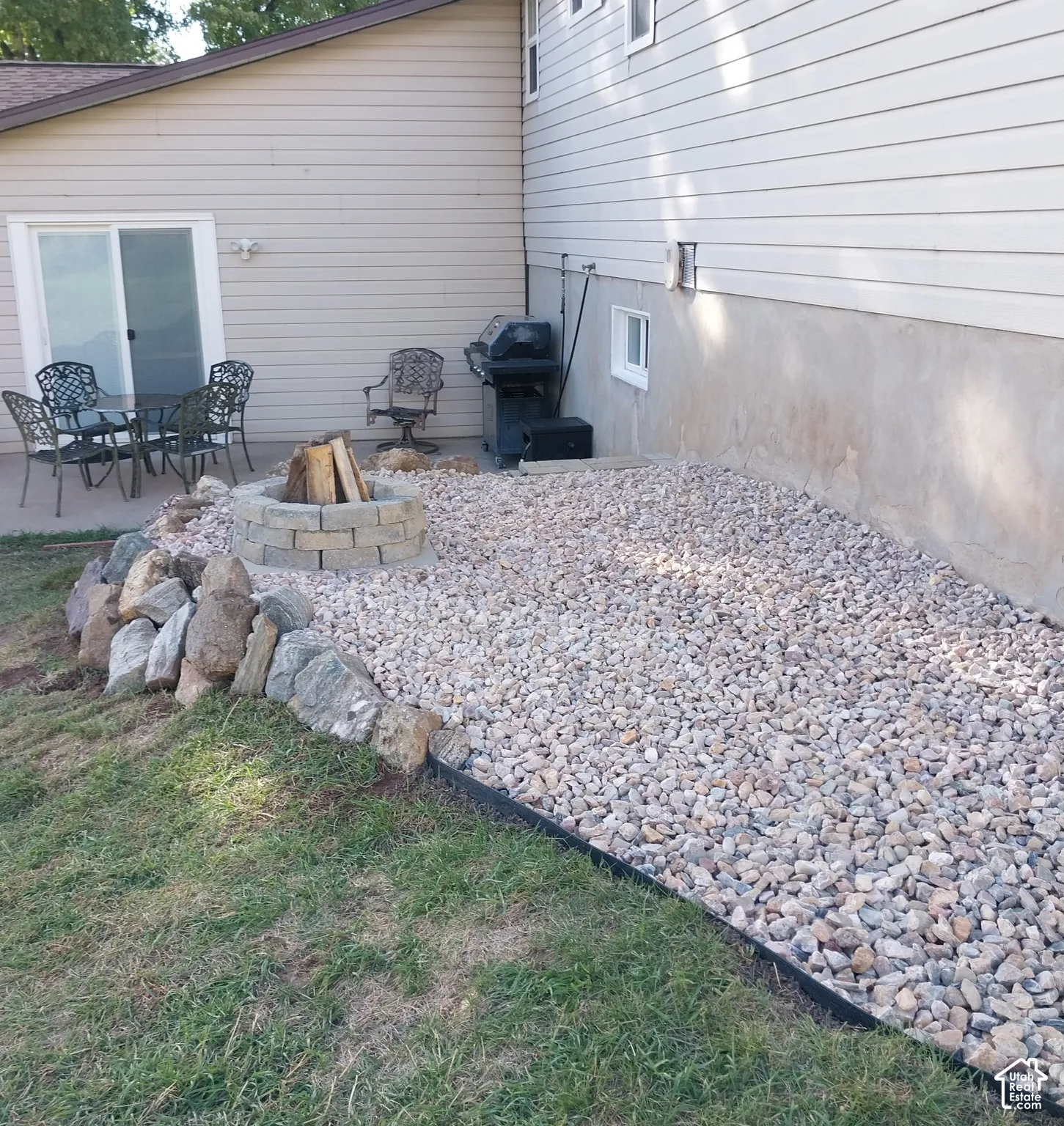 Stone fire pit area with gravel hardscaping