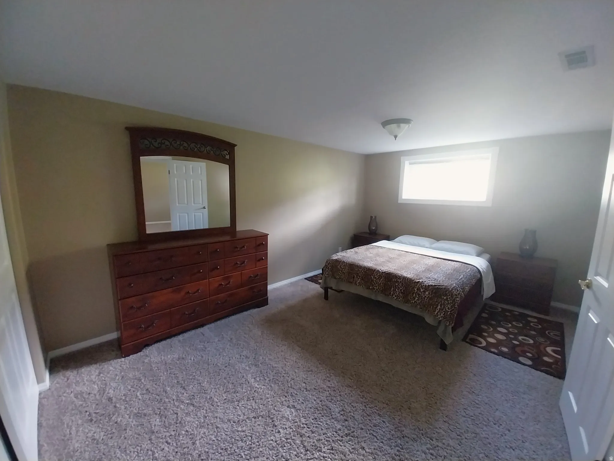 Bedroom with carpet flooring and baseboards