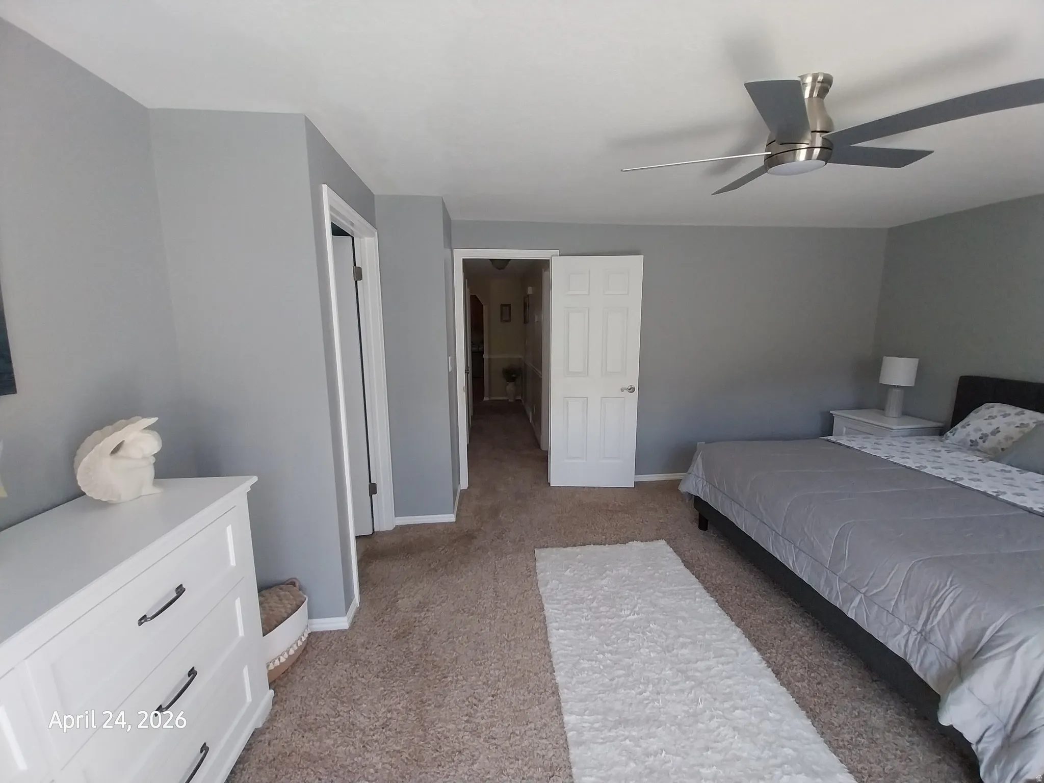 Bedroom with light colored carpet and ceiling fan