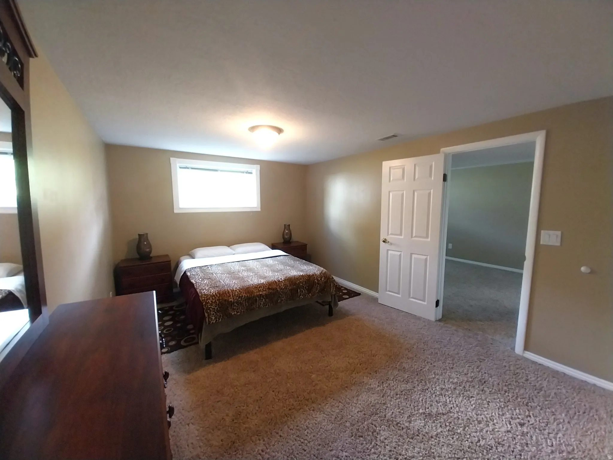 Carpeted bedroom with baseboards