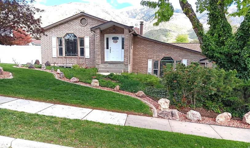 View of front of house with a mountain view and brick siding