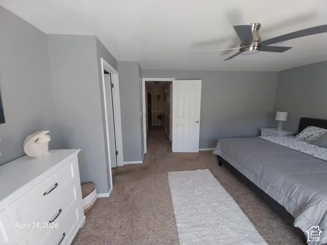 Bedroom with light colored carpet and ceiling fan