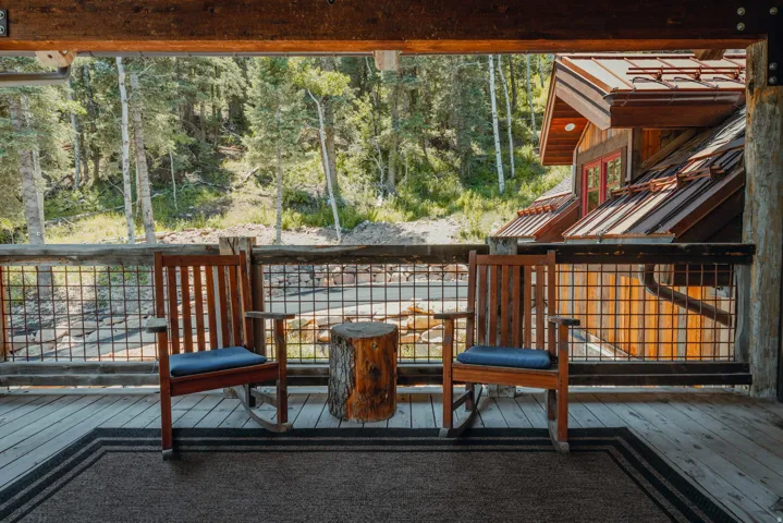 Spacious wood deck featuring rustic wood railing with grid infill