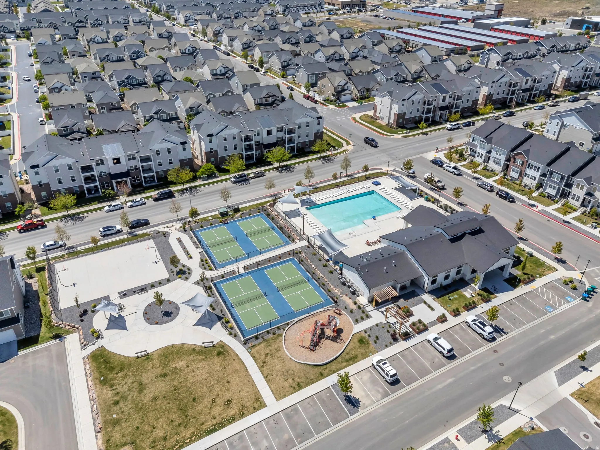 Community amenities featuring a swimming pool, two tennis courts, a sand volleyball court, and a playground