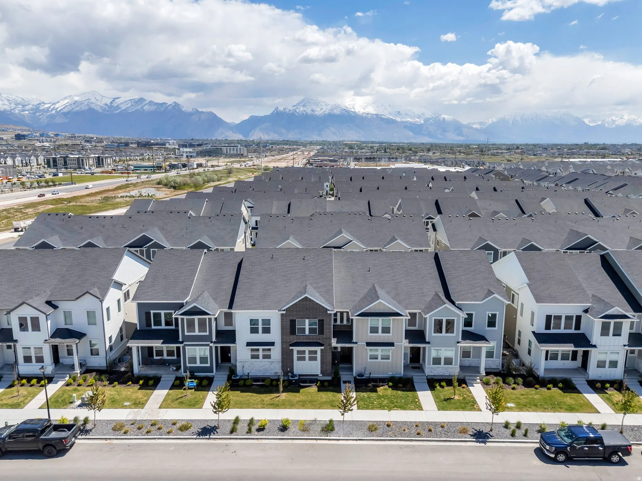 Modern townhome community featuring diverse siding materials and gabled roofs