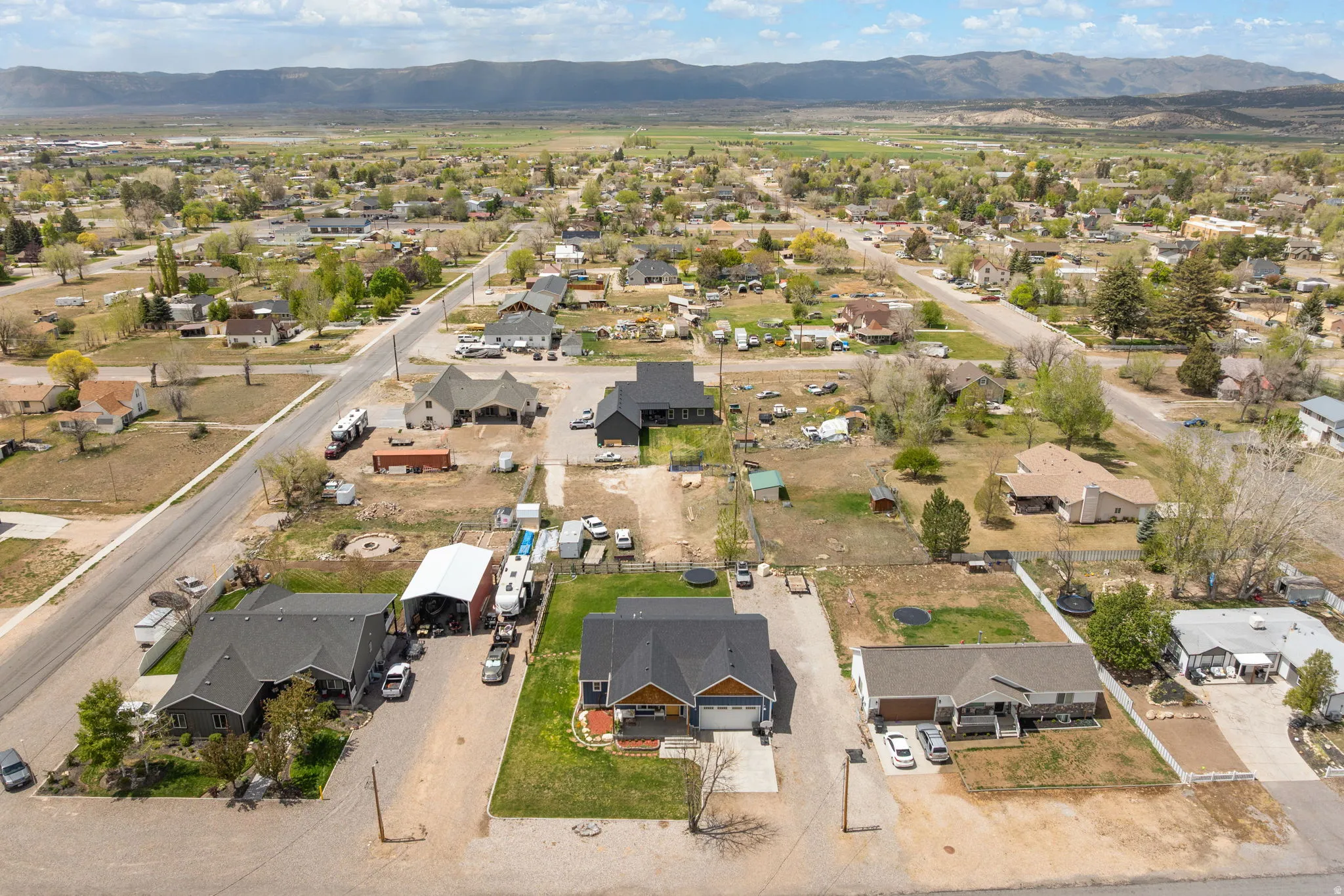 Aerial perspective showcasing a residential neighborhood with distant mountains