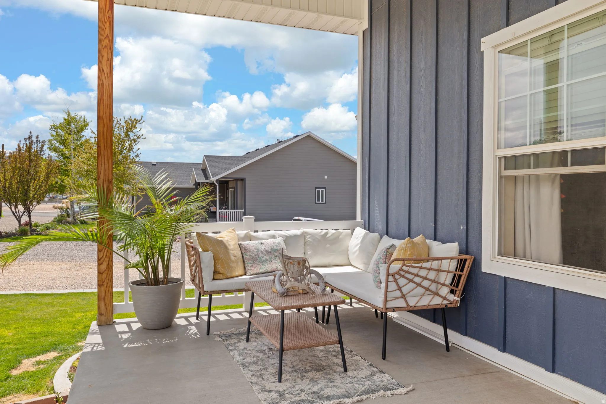 Covered porch featuring a concrete slab and a wooden support column