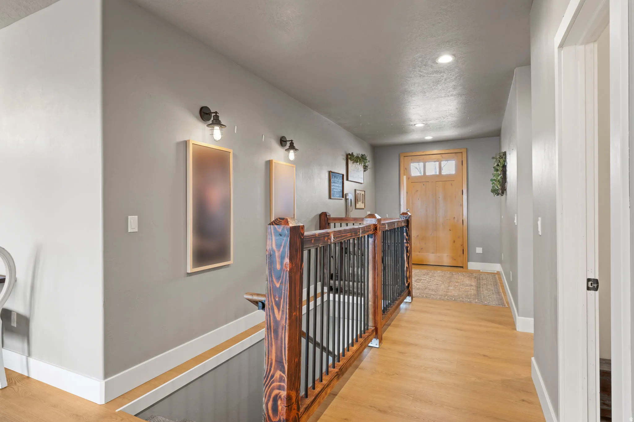 Entry featuring wood-finish flooring and a wood door with glass paneling