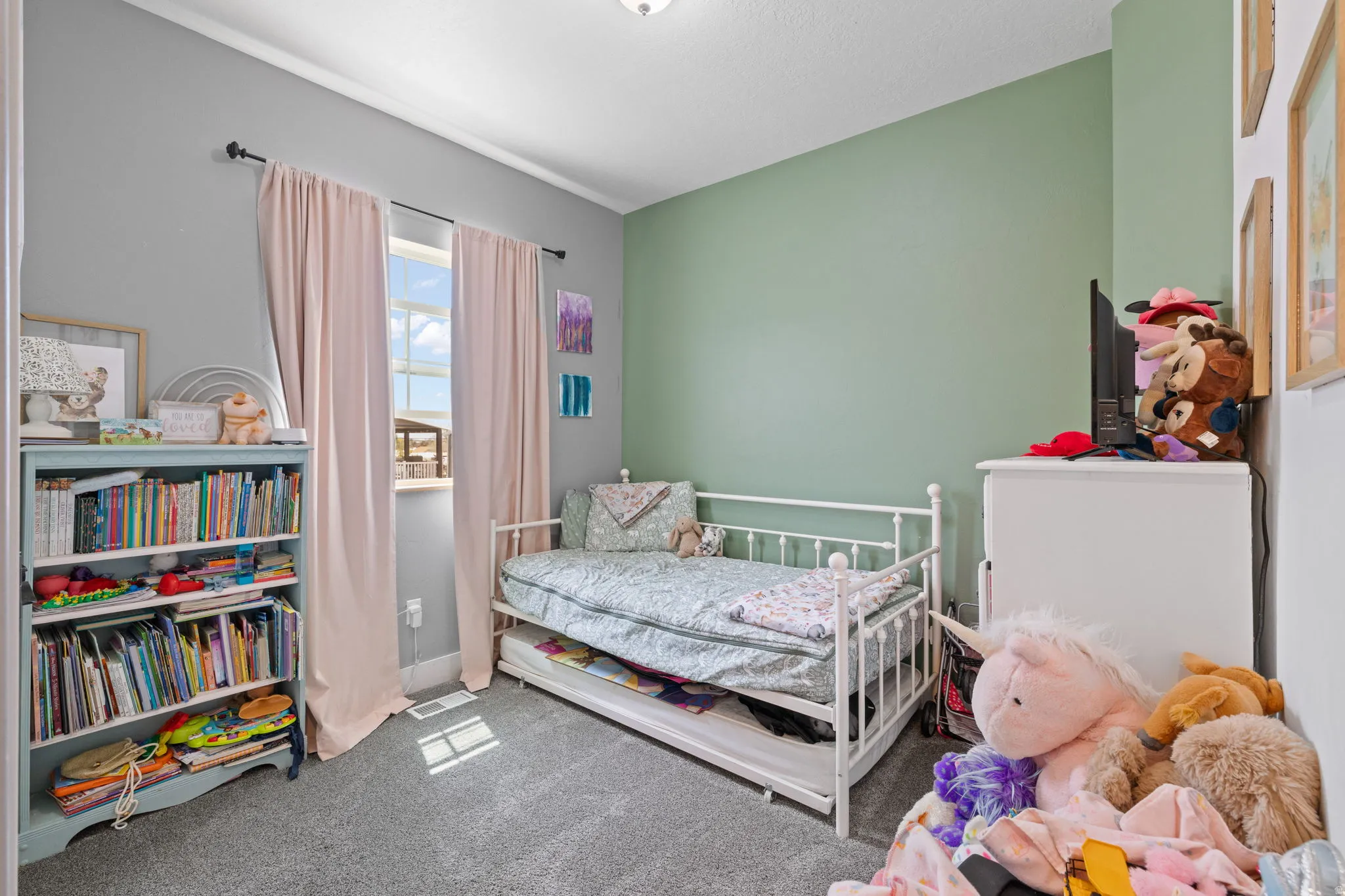 Bedroom featuring a double-paned window, neutral wall paint, and gray carpet flooring