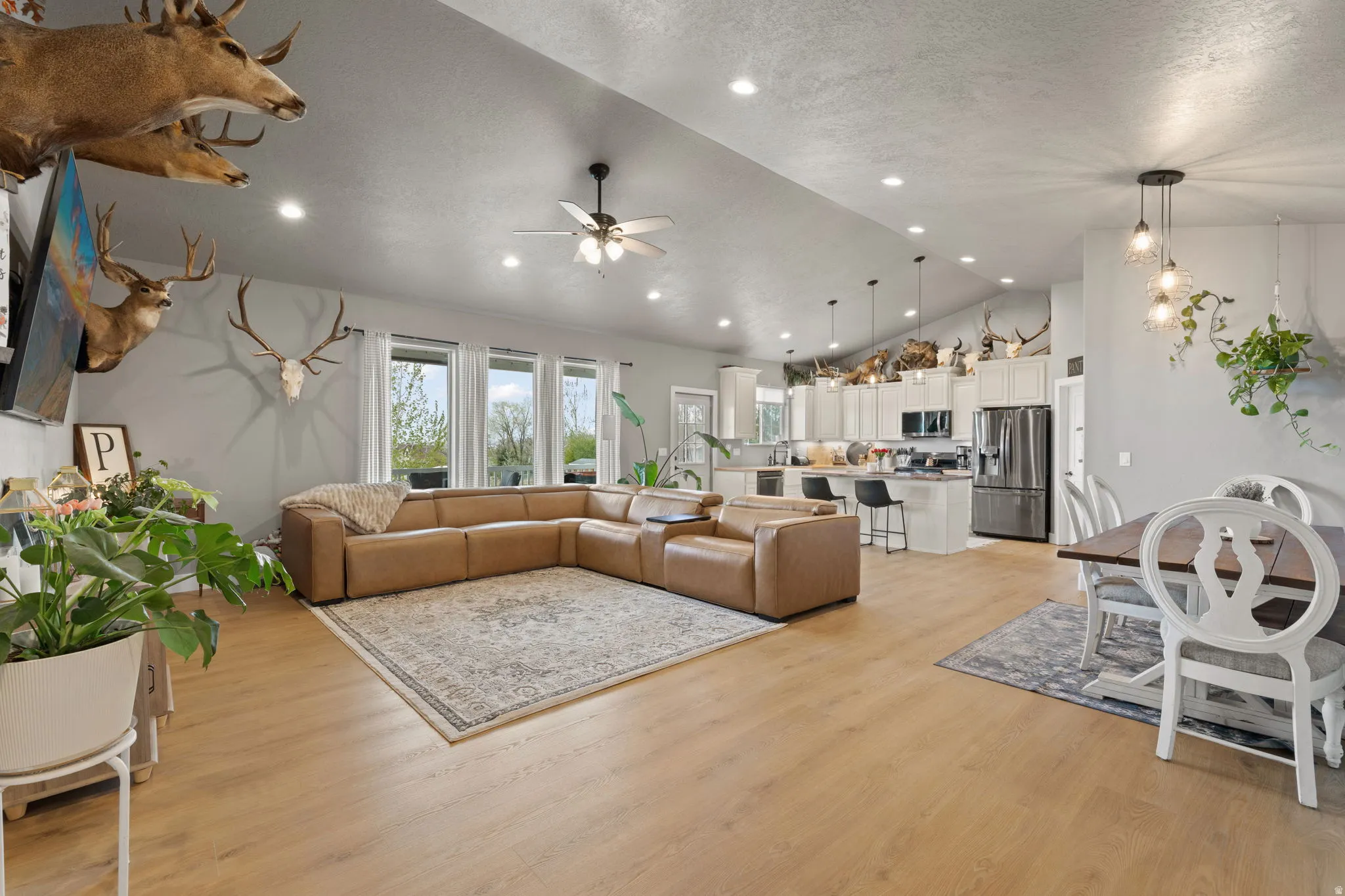 Open-concept living space featuring wood-finish flooring and recessed lighting