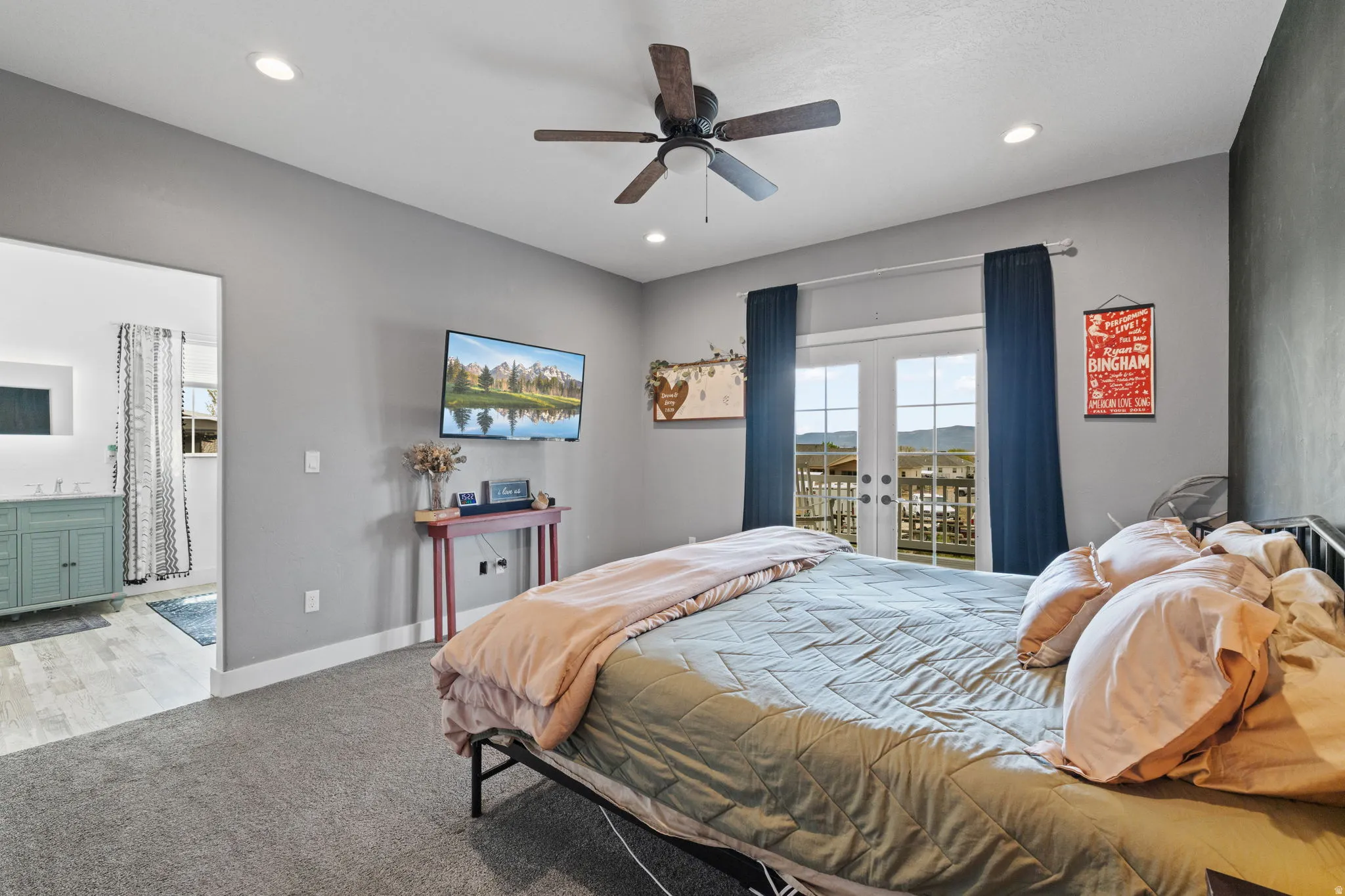 Primary Bedroom with en-suite, featuring light grey walls, recessed lighting, and a ceiling fan