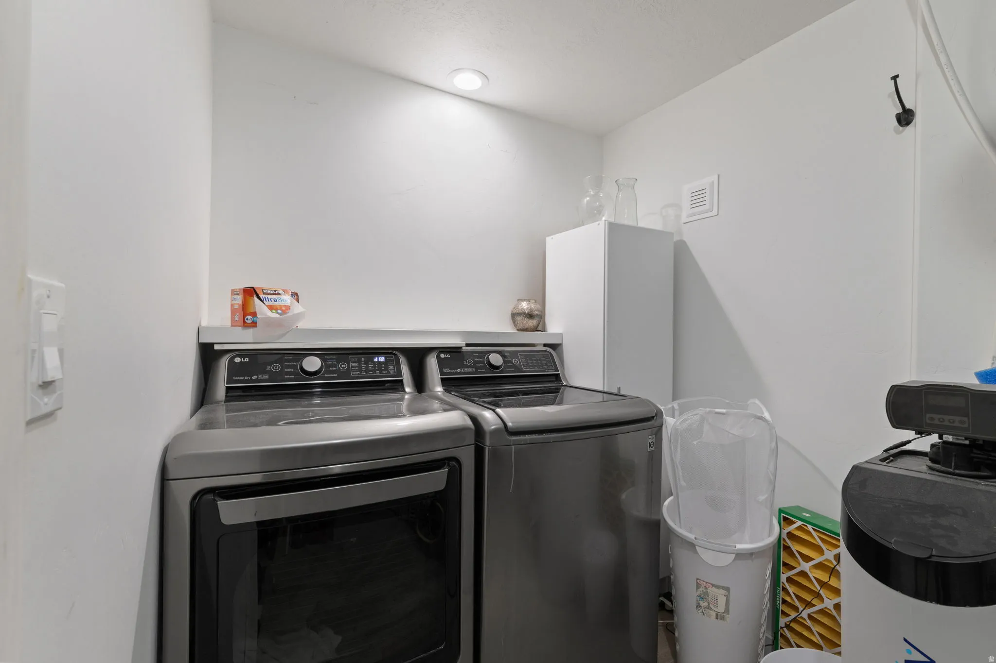 Dedicated 2nd basement laundry area featuring a white countertop and recessed lighting