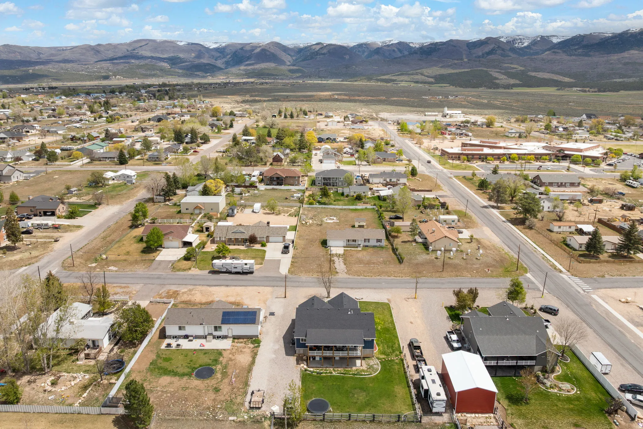 Aerial perspective showcasing a residential neighborhood with distant mountains