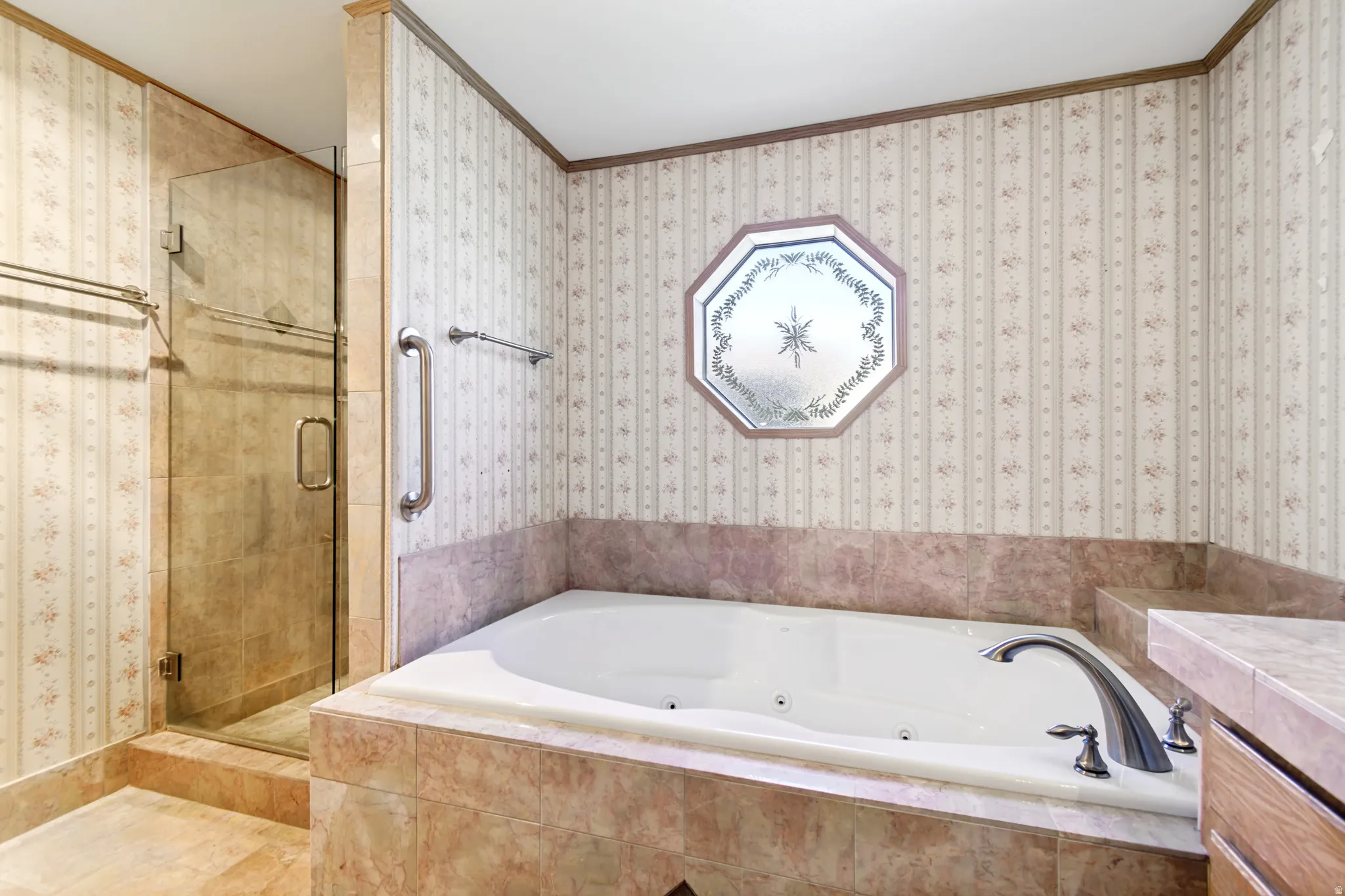 Full bathroom with a tub with jets, wallpapered walls, a shower stall, ornamental molding, and vanity