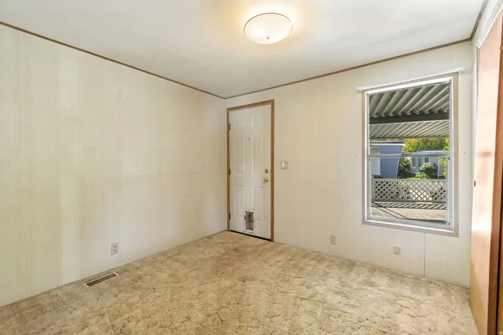 Spare room featuring carpet and crown molding