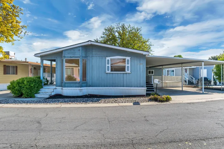 Manufactured / mobile home with an attached carport and a porch