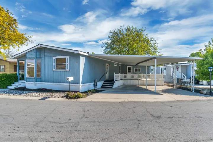 Manufactured / mobile home with a carport and entry steps