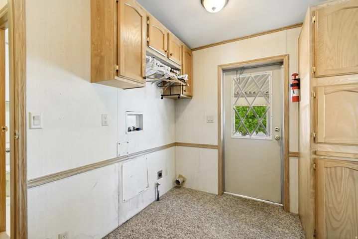 Laundry area with light carpet, hookup for a washing machine, cabinet space, and hookup for an electric dryer