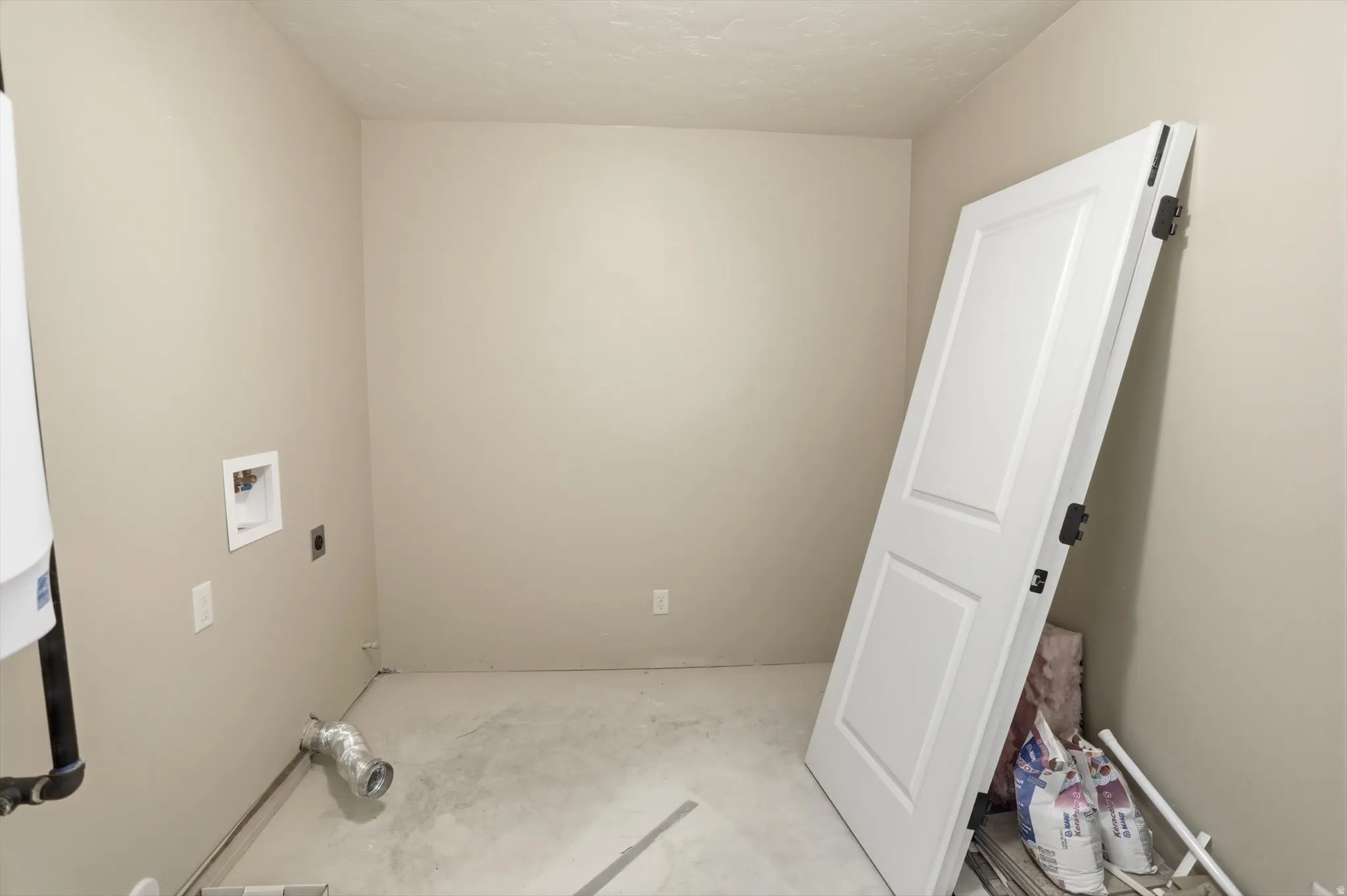 Utility room featuring neutral wall paint, a washer hookup, and a dryer vent