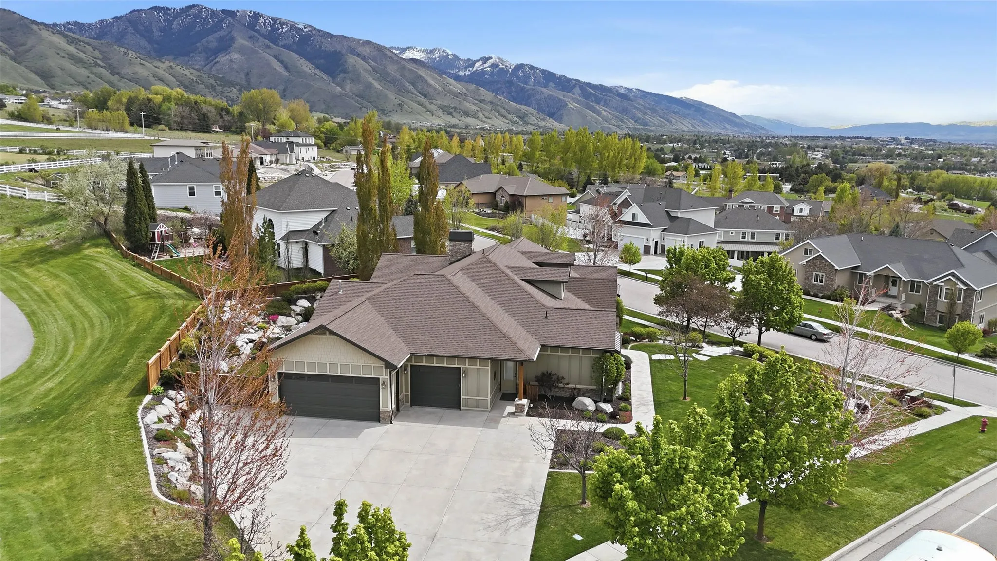 Contemporary residence featuring a multi-gabled roofline and a two-car garage