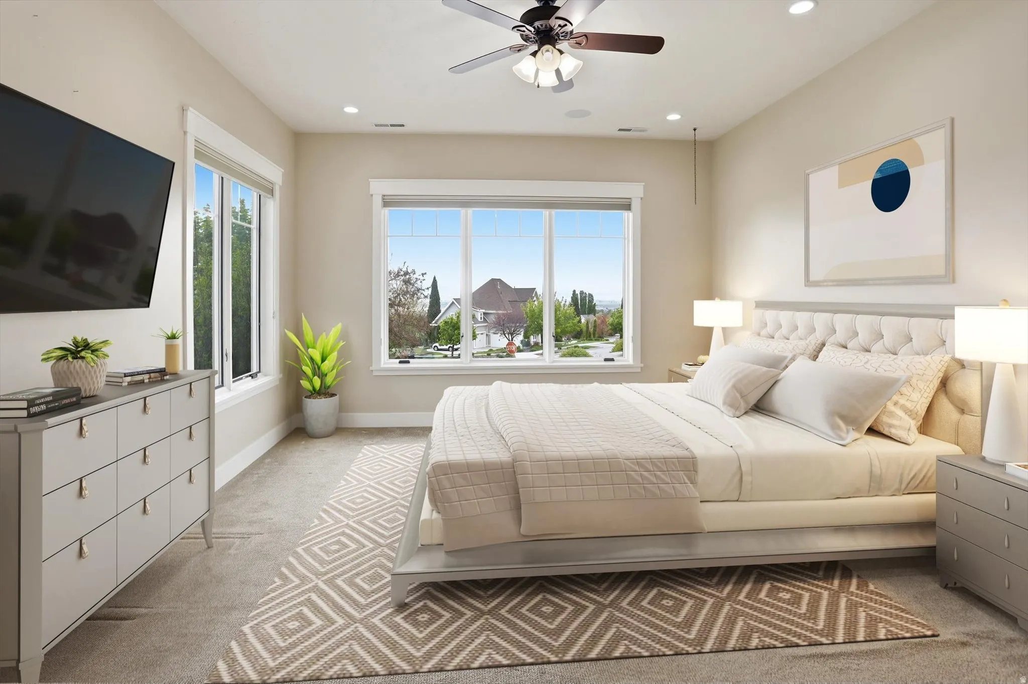 Carpeted room featuring multiple windows, recessed lighting, and a ceiling fan