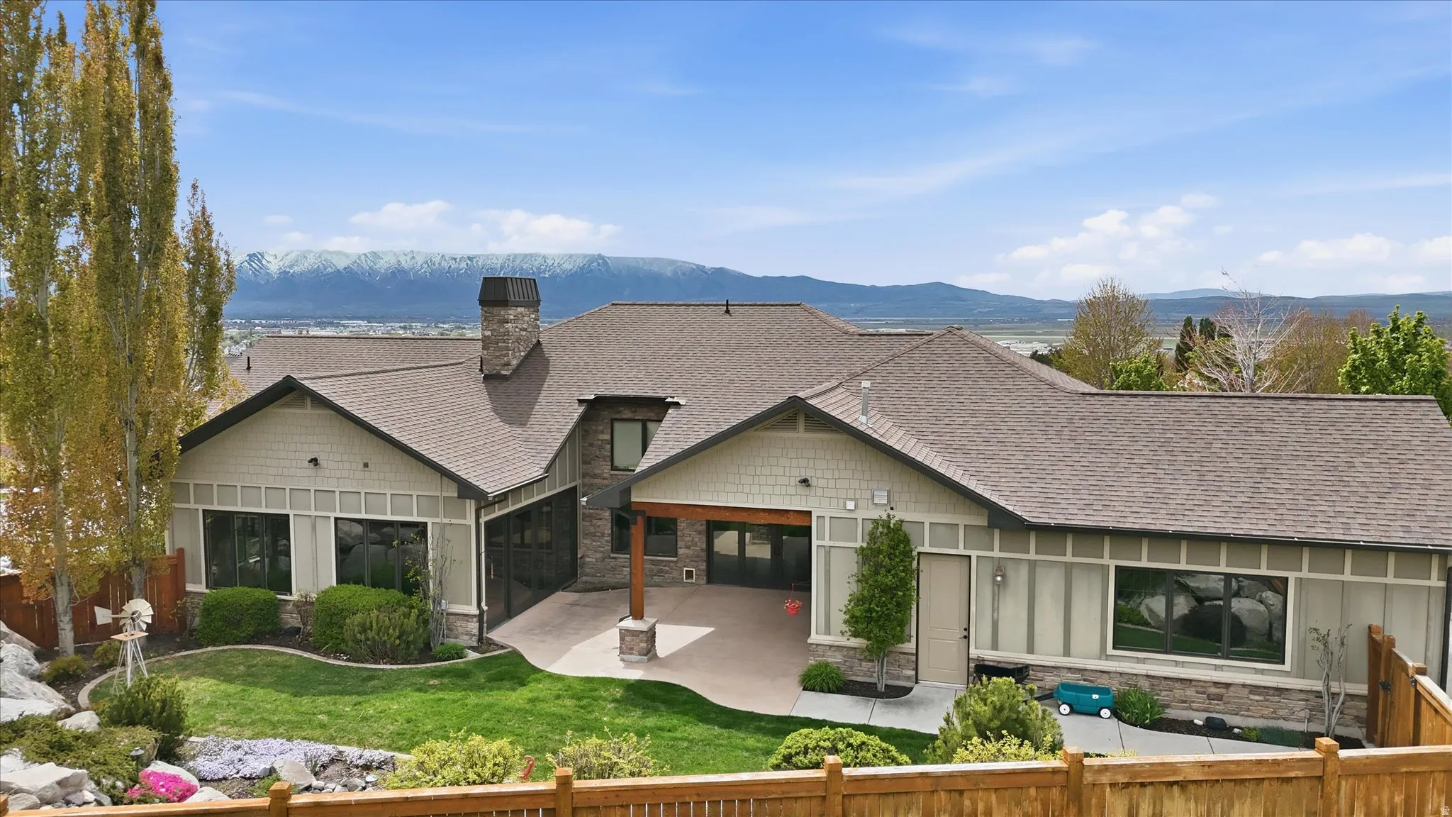 Modern ranch-style residence featuring a combination of horizontal siding, shake siding, and stone accents