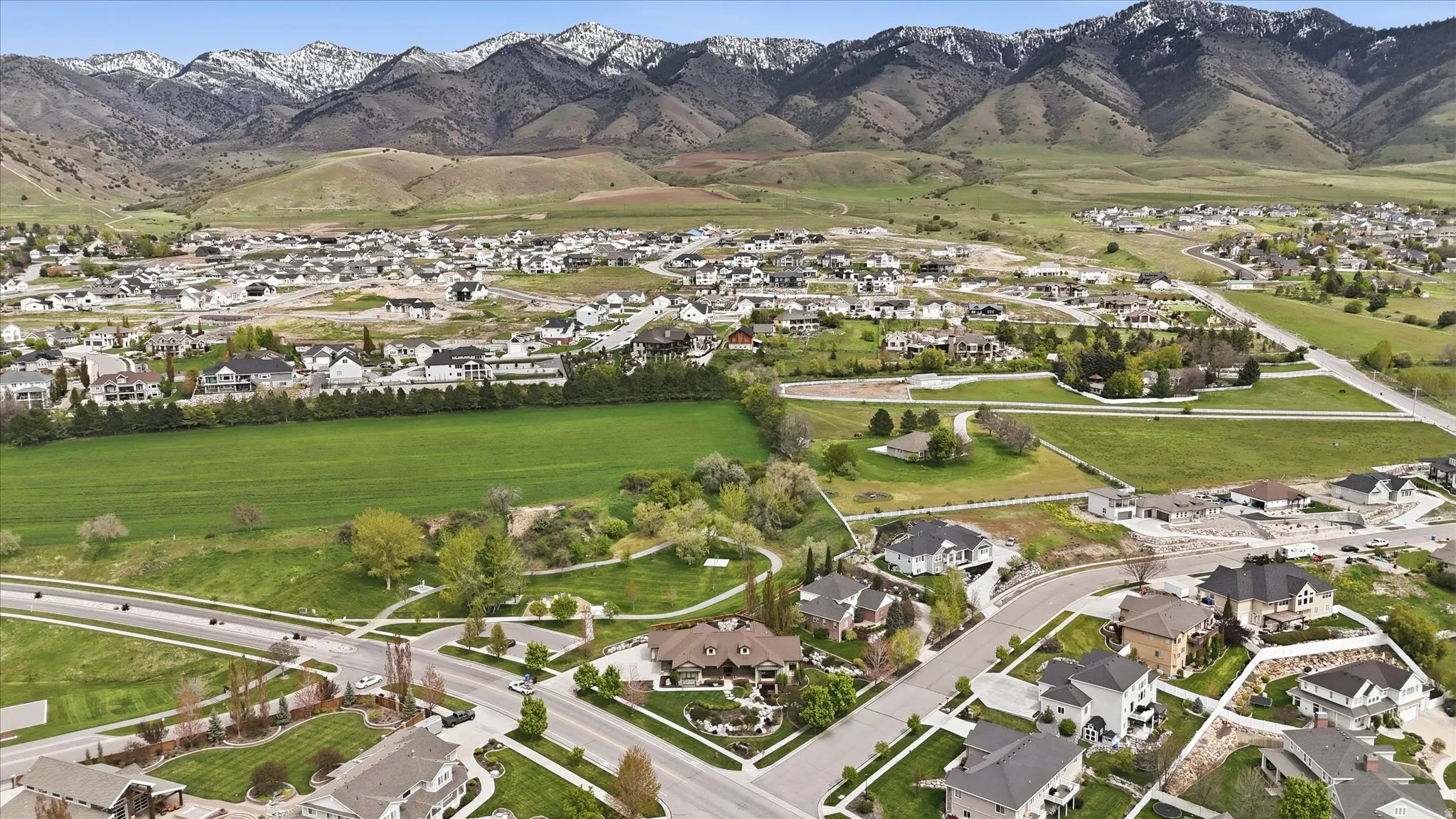 Expansive aerial perspective showcasing a residential development with prominent mountain backdrops
