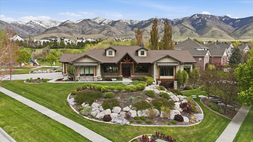 Craftsman-style home featuring a prominent front gable, stone veneer accents, and a covered entry with timber detailing