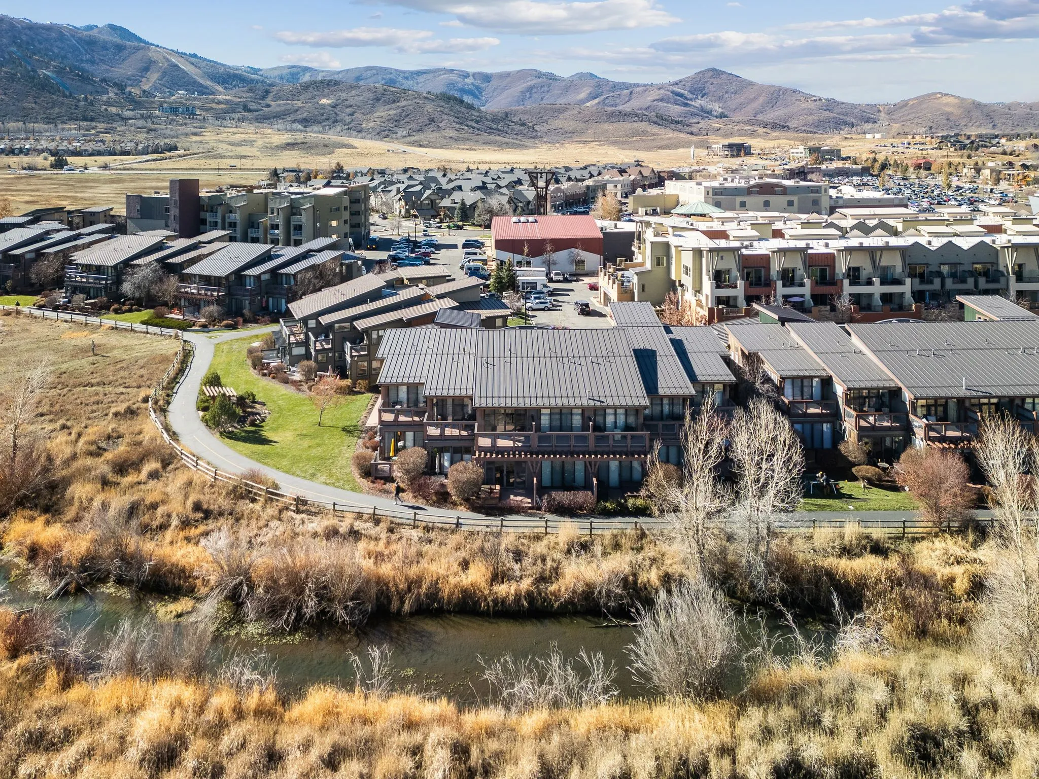 Multi-story residential buildings featuring metal roofs and multiple balconies