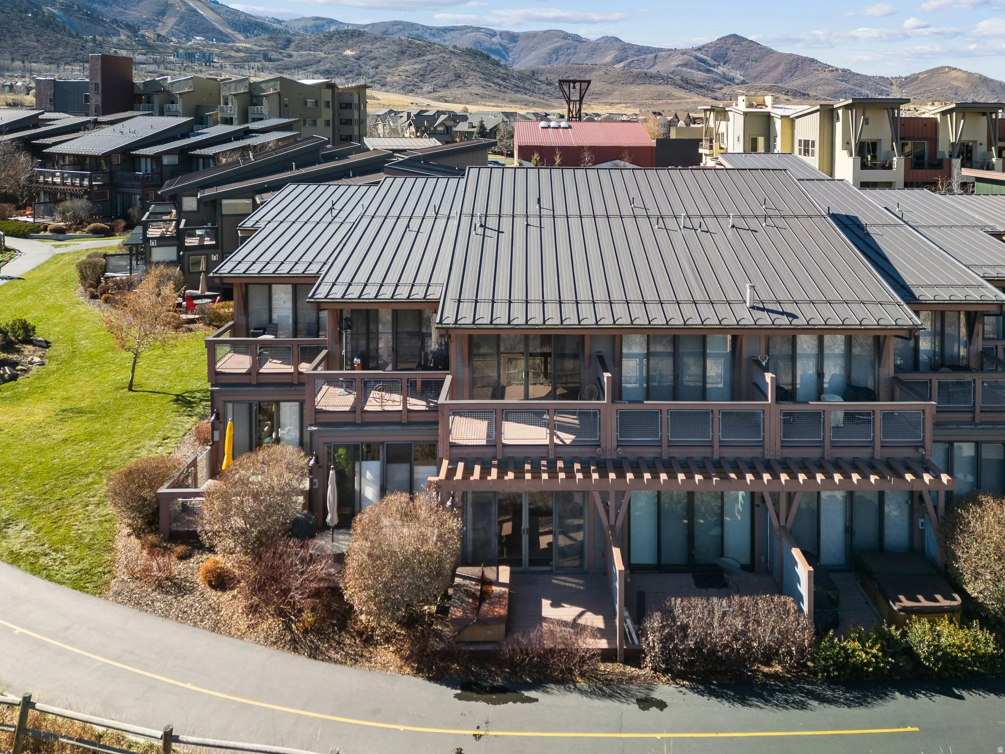 Contemporary multi-level townhome featuring a metal standing seam roof and multiple private decks