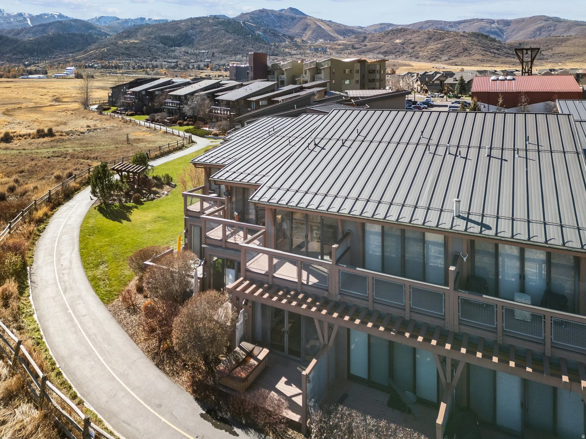Modern multi-level building featuring a standing seam metal roof and expansive decks