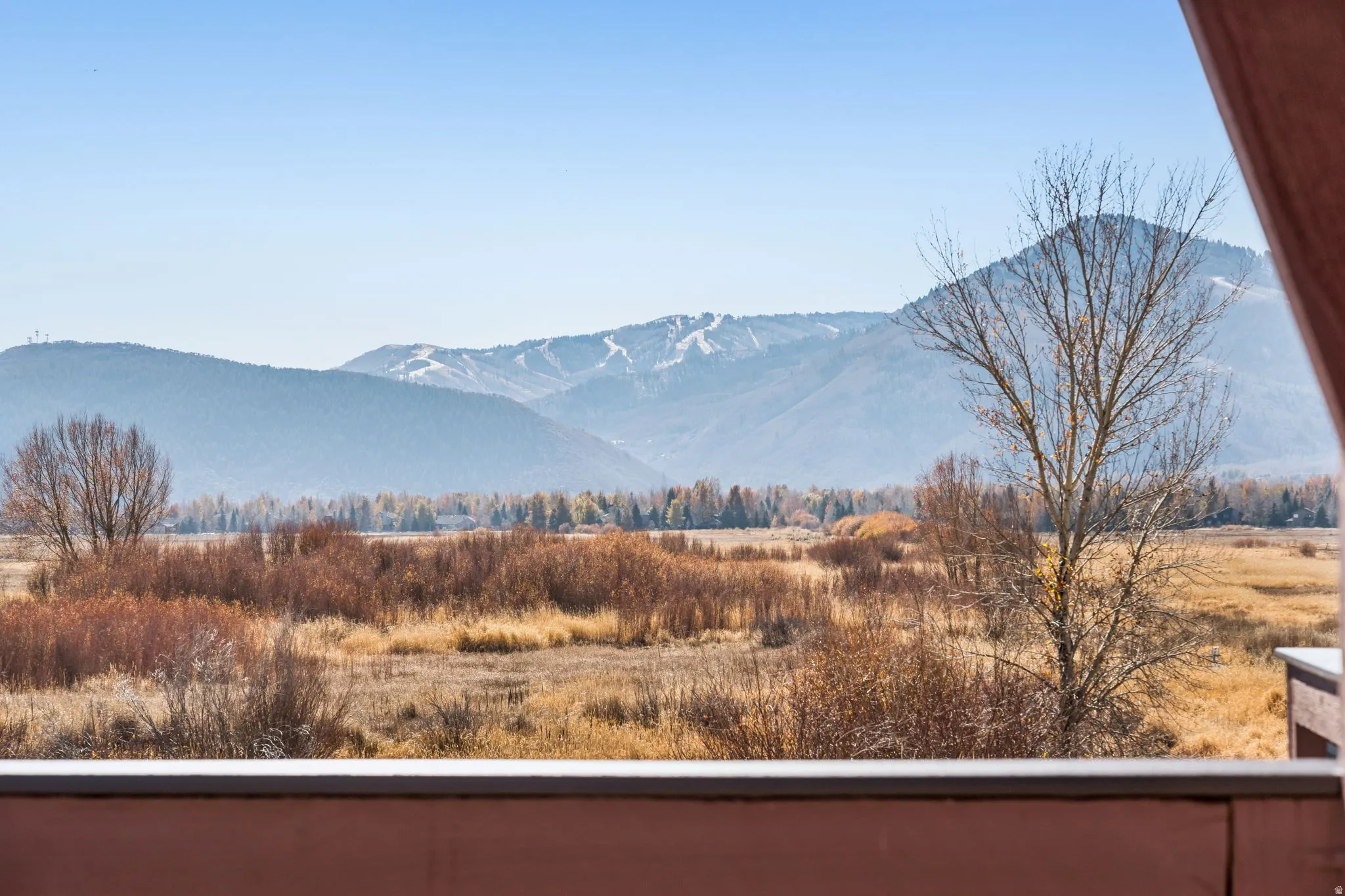 Expansive mountain backdrop featuring ski runs and a wide valley