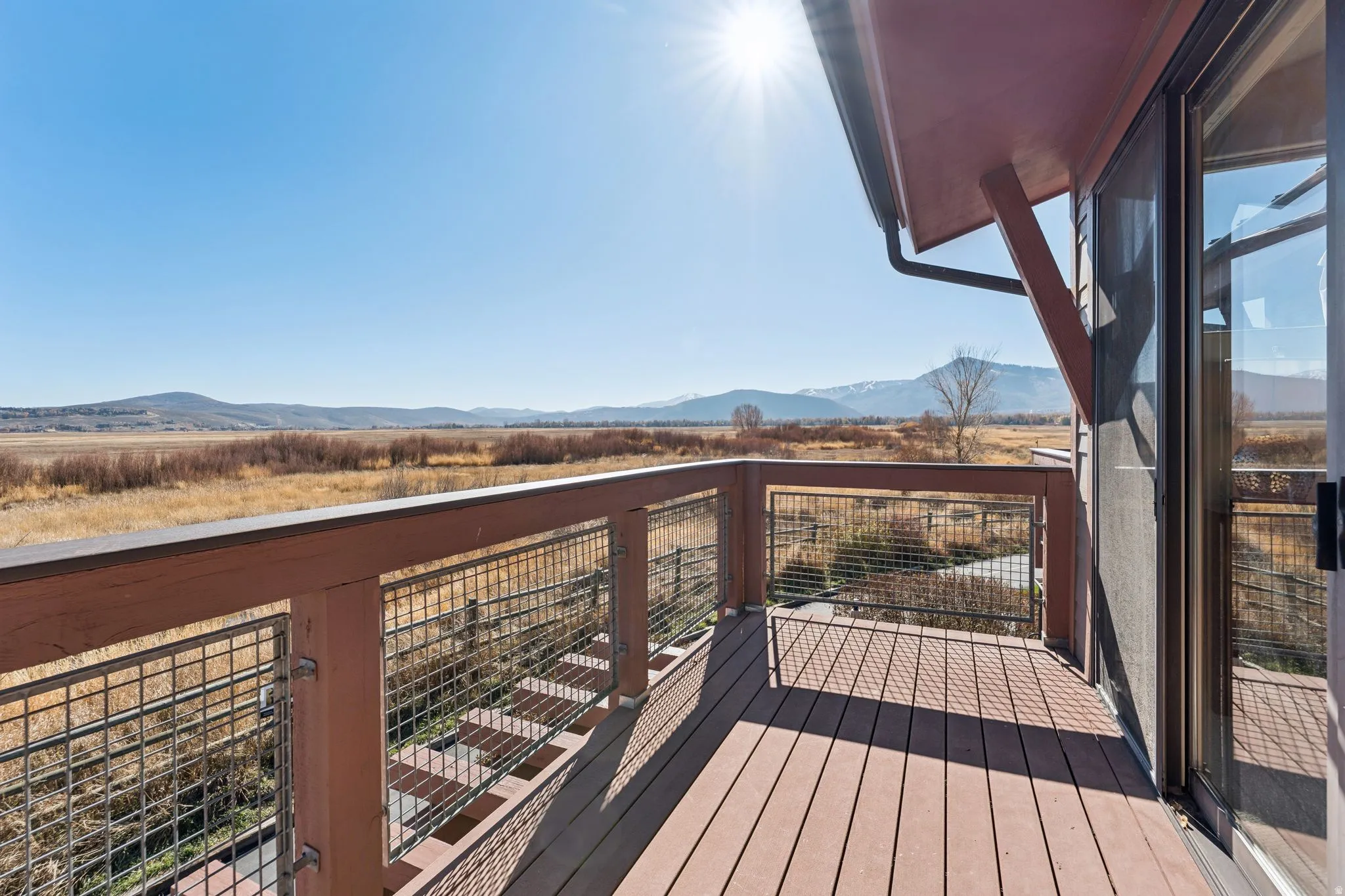 Private outdoor deck with composite decking and wire mesh railing