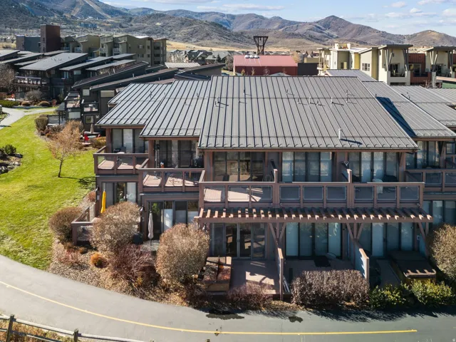 Contemporary multi-level townhome featuring a metal standing seam roof and multiple private decks