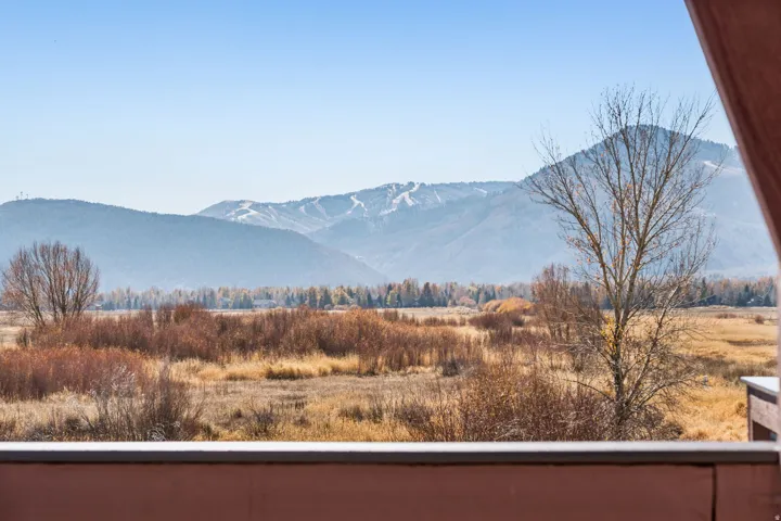 Expansive mountain backdrop featuring ski runs and a wide valley