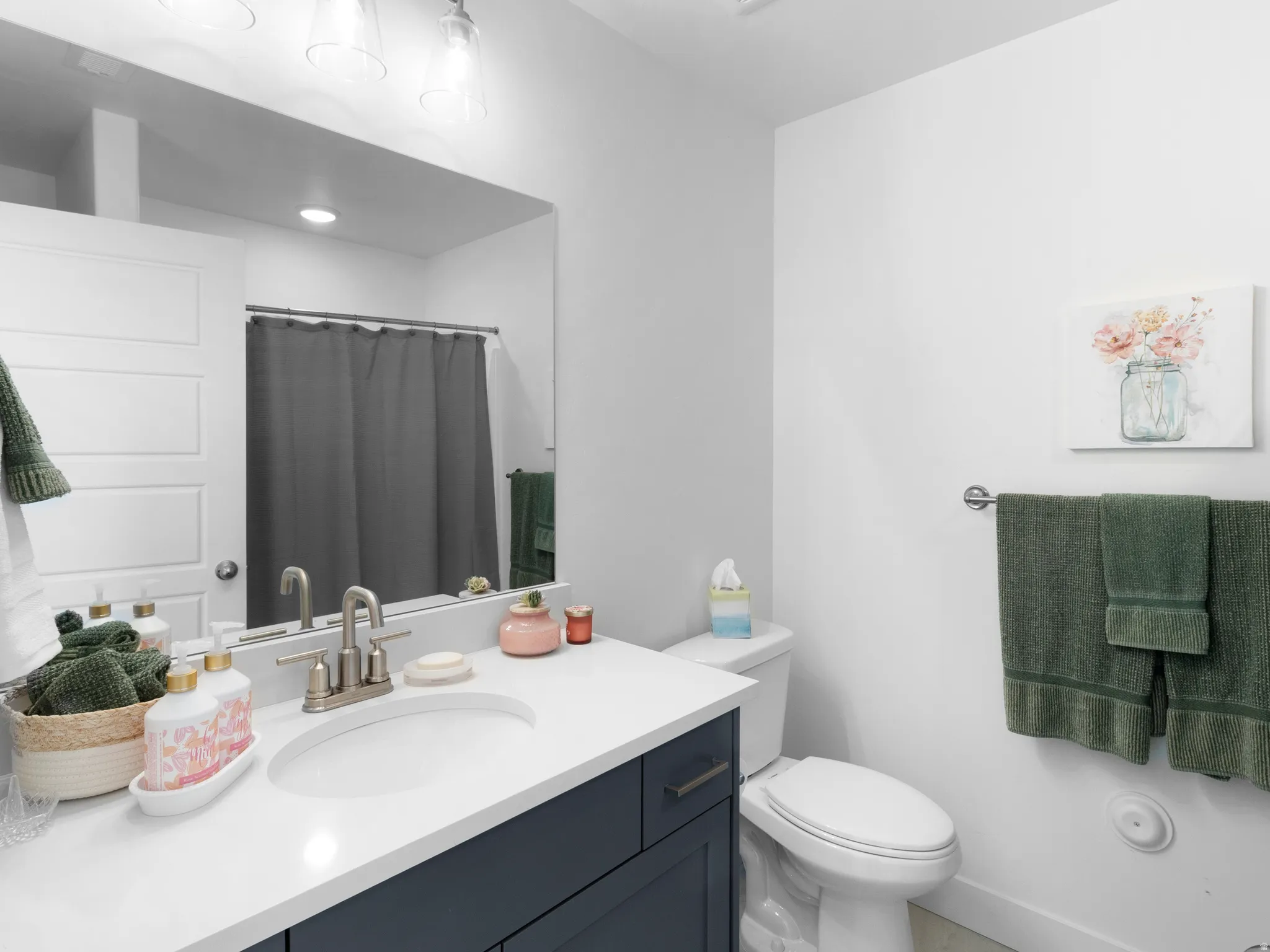Full bath featuring vanity and curtained shower