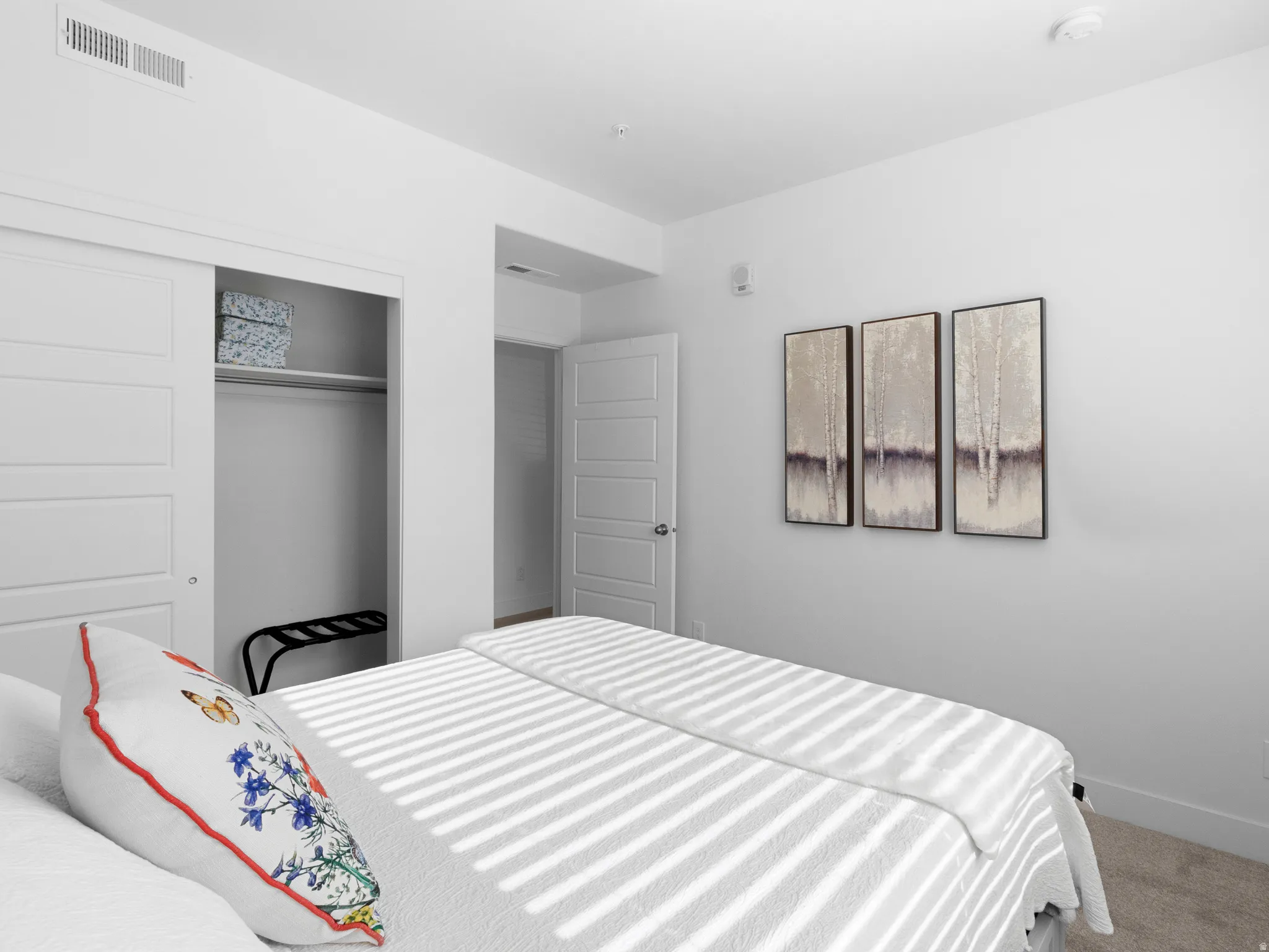 Bedroom featuring carpet flooring and a closet
