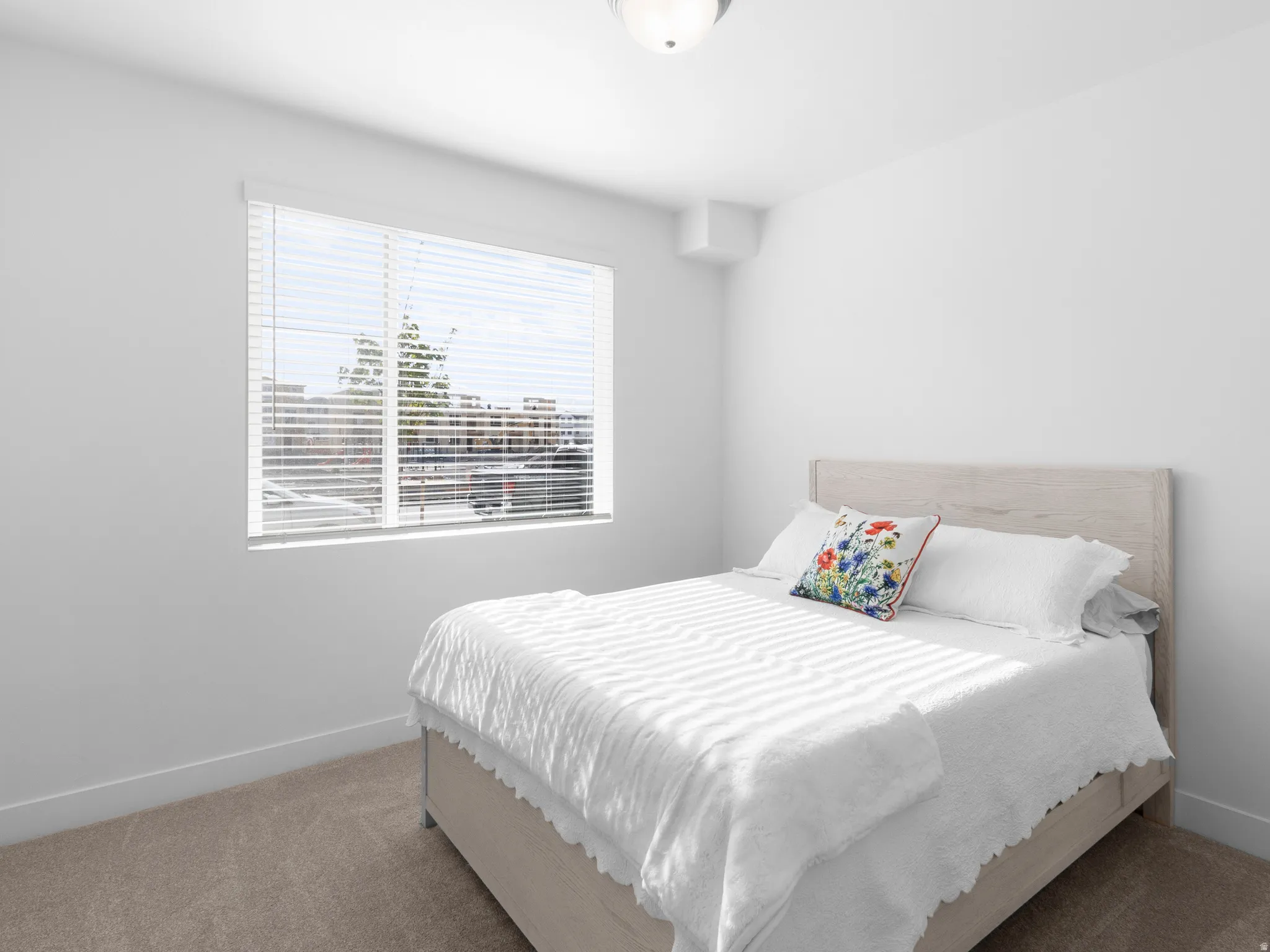 Bedroom featuring carpet flooring and baseboards