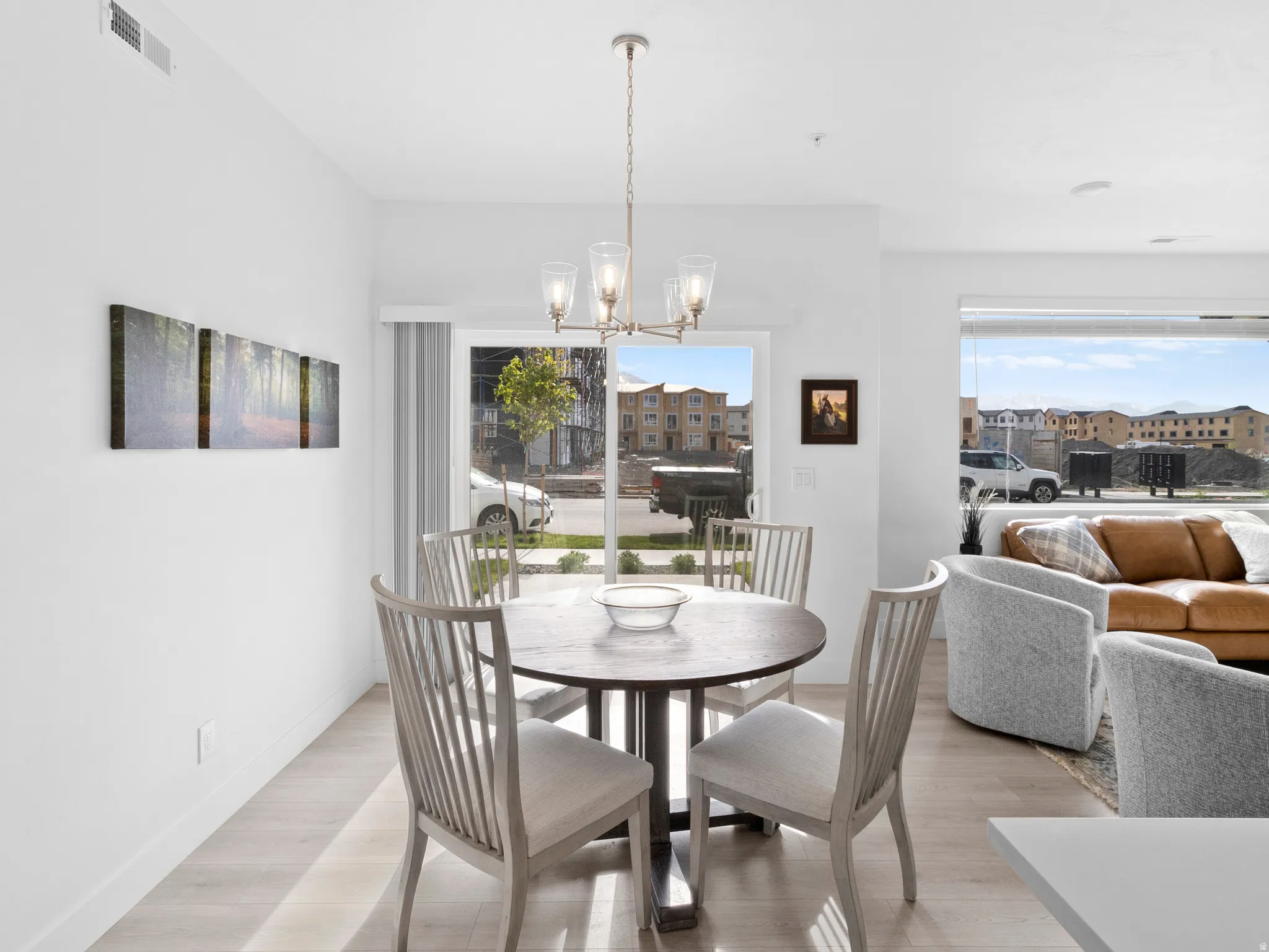 Dining room with hanging lights and light wood-style floors