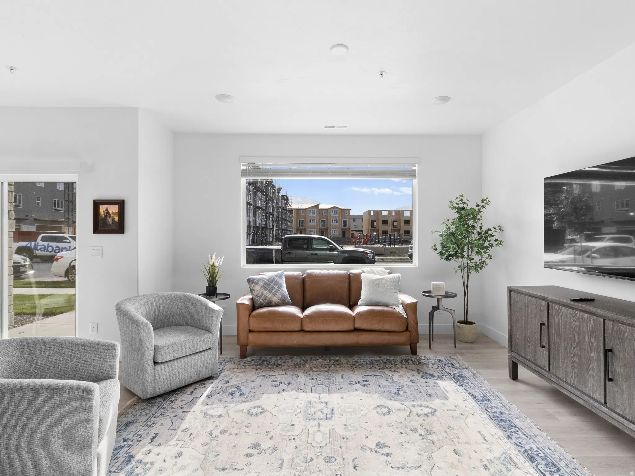 Living room with light wood finished floors and baseboards