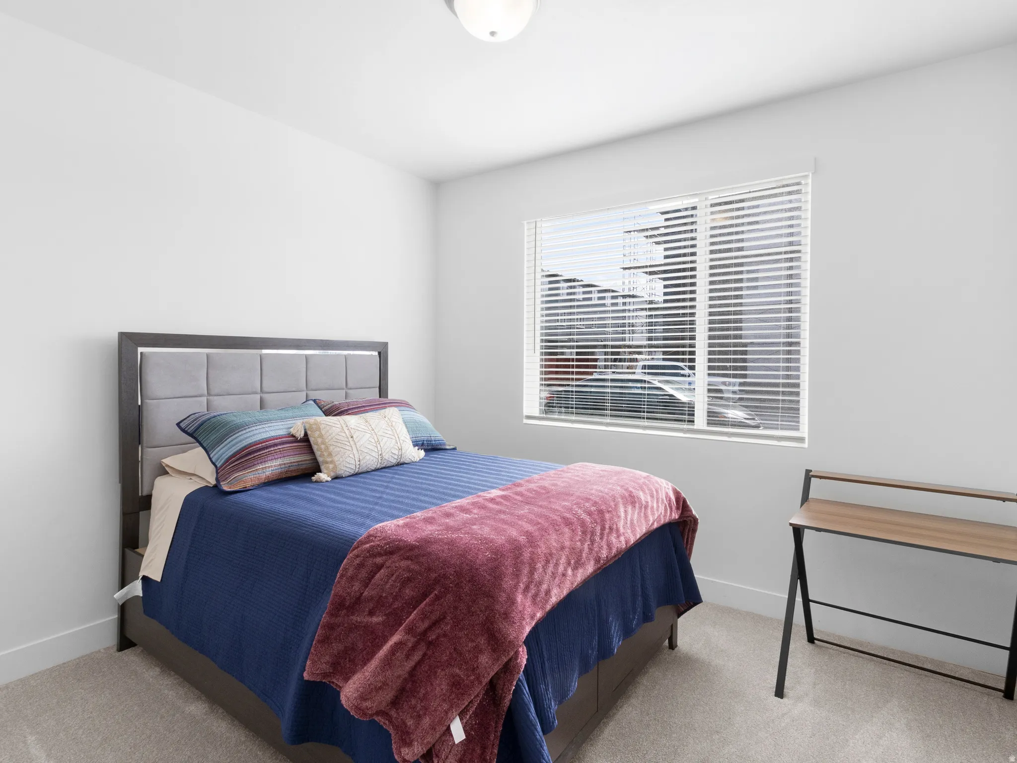 Bedroom featuring light colored carpet