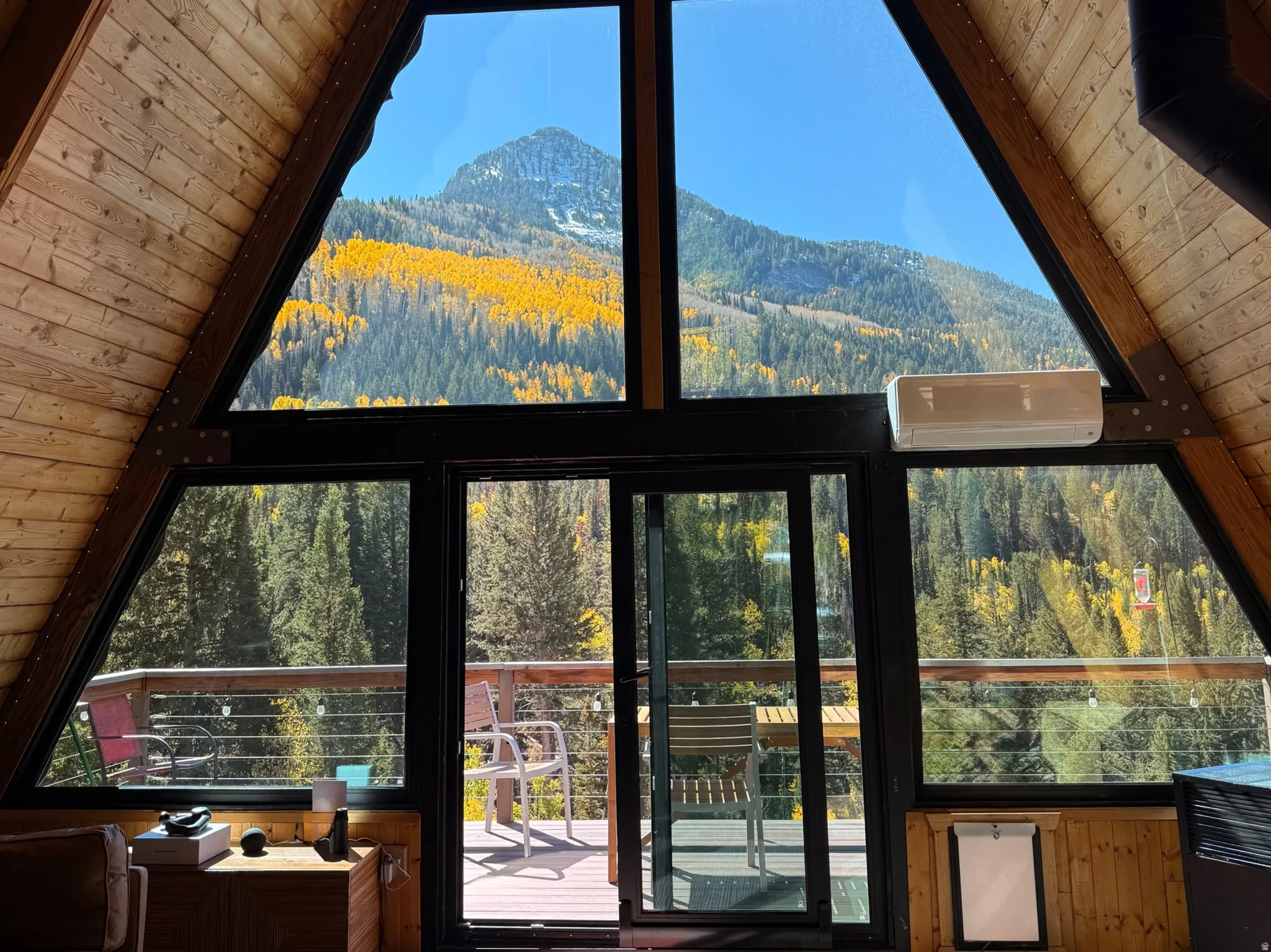 Vaulted wood-paneled ceilings with expansive A-frame window frontage