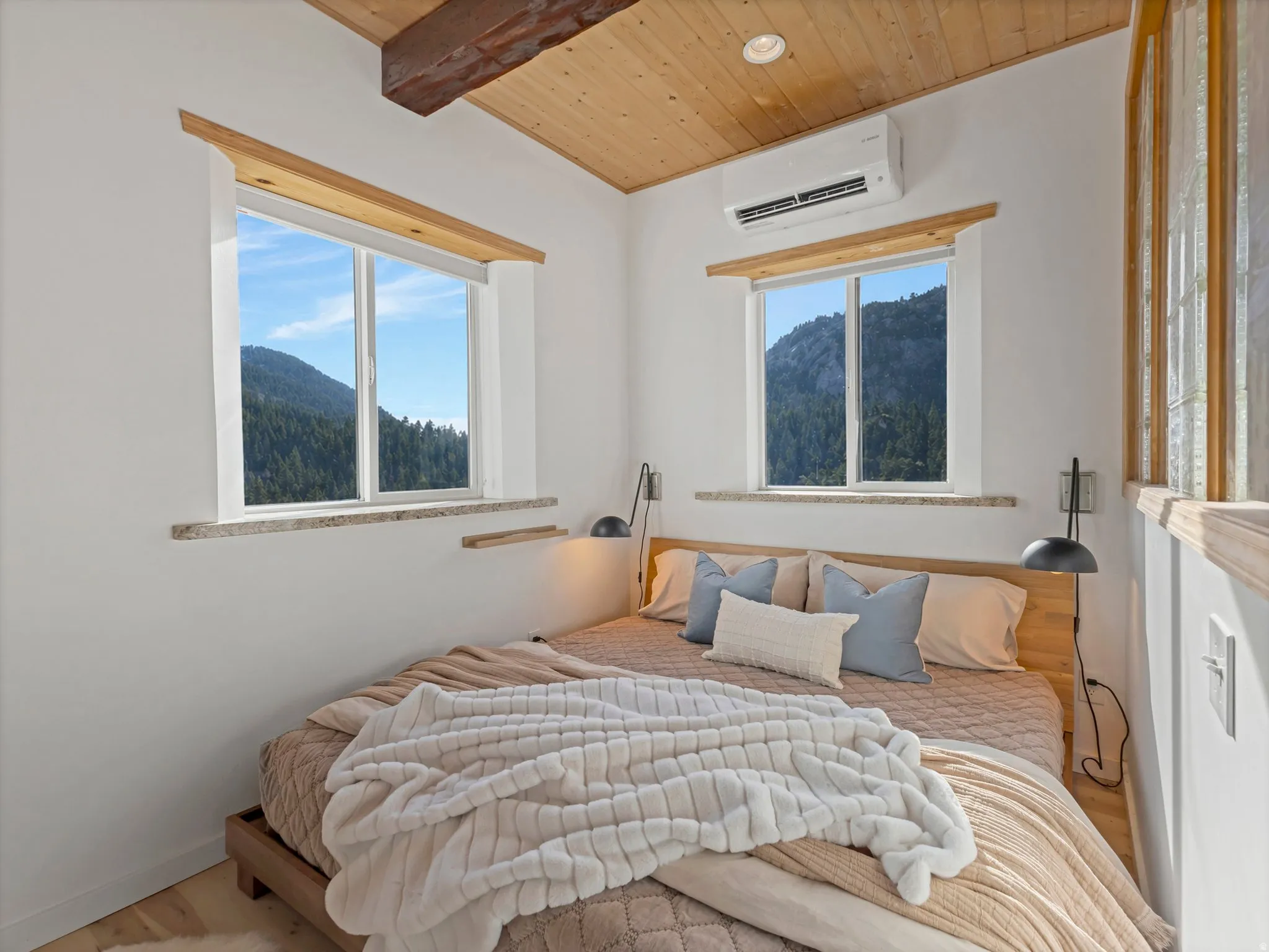 Bedroom featuring a wooden ceiling with exposed beams, wood finished floors, a mountain view, and recessed lighting