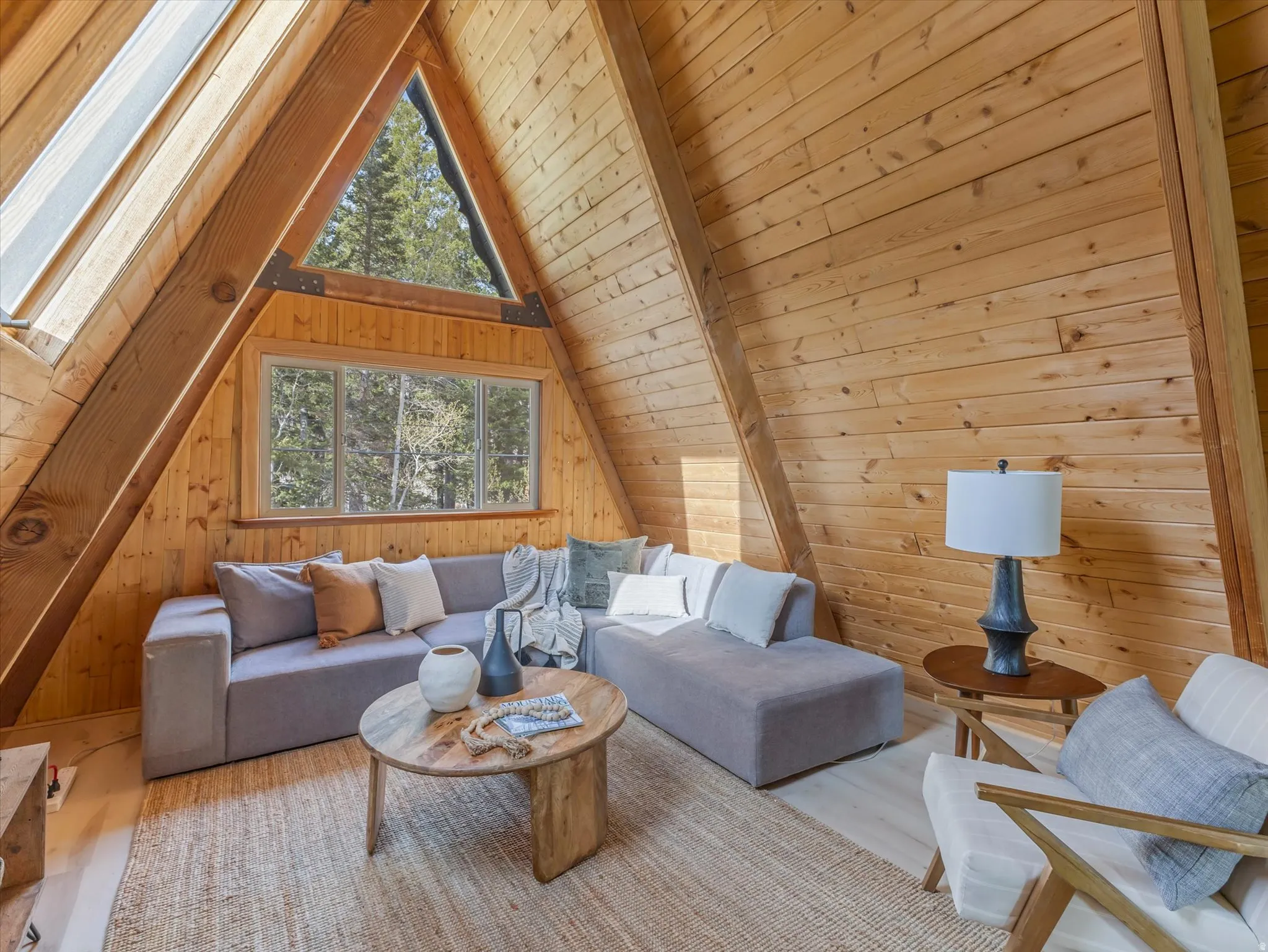 A-frame interior featuring natural wood plank walls and exposed wood beams