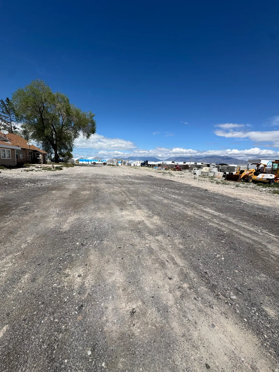 Expansive gravel lot with distant mountain backdrop