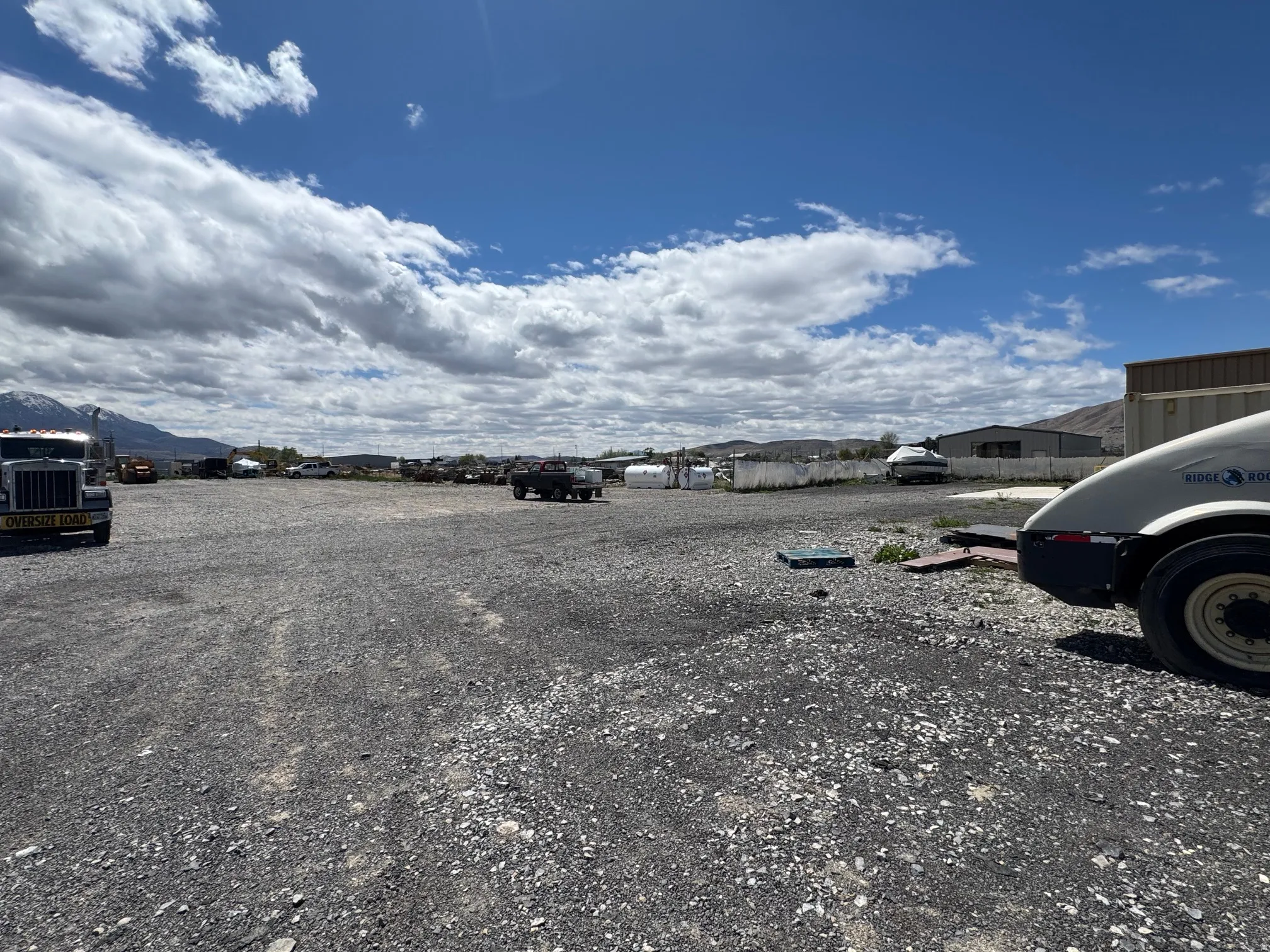 Expansive gravel lot with mountain scenery